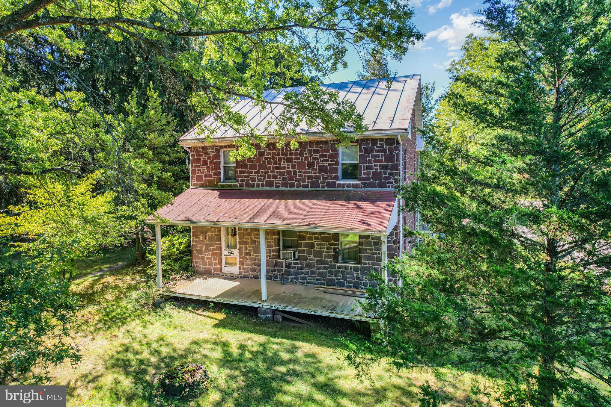Welcome to 2350 Felty Mill Road, a rare 42.38-acre parcel in Derry Township offering endless possibilities! Nestled on the property is a charming old stone farmhouse full of character. The main level features a cozy family room with a wood-burning fireplace that flows into the kitchen with an eat-in dining area. Convenient main level laundry room and full bath. Upstairs, you’ll find three bedrooms and another full bath. Outdoor living can be enjoyed on the front patio overlooking the peaceful surroundings. A barn, while in need of repair, holds potential for restoration. The land itself is truly the highlight—expansive acreage with mature trees and sweeping views. With plenty of space for recreation, farming, or simply enjoying nature, this property is a unique find. With ample road front and already cleared acreage, this parcel is perfect for development or multi-family living. The old stone farmhouse is waiting for you to restore it to it’s original character! All just minutes from Hershey’s many amenities, this one-of-a-kind opportunity blends rural tranquility with convenience. A joy to own!