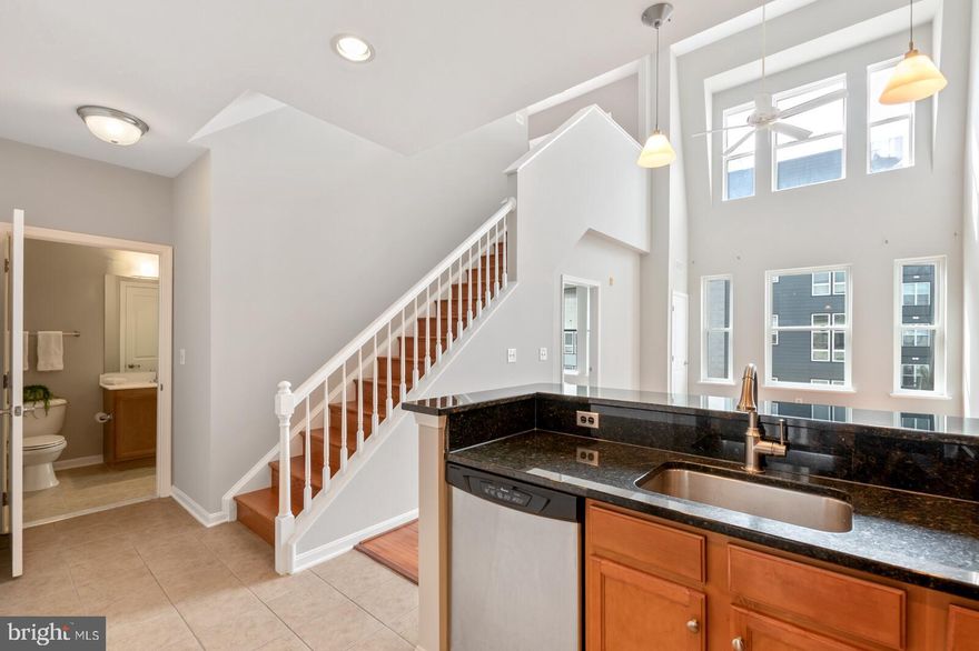 Live in the bustling MOSAIC DISTRICT(Merrifield, VA) in this contemporary TOP FLOOR (2-story), PENTHOUSE 1BR/1BA w/LOFT(spare bedroom/office/library) located next to DUNN LORING Metro! NEWER hardwood floors thru-out, kitchen w/GRANITE & SS appliances 2-story dining/living room with CATHEDRAL ceiling with allows an abundance of NATURAL LIGHT. BRAND NEW full size front load Washer and Dryer!  This unit is conveniently located near the parking garage and the elevators(convenient for hauling groceries).  Take advantage of the secure entry system for the building and vast amenities to include: elegant library, party room, newer gym, indoor basketball court, pool, hot tub & more.  Restaurants, bars, shops, movie theatre, farmers markets, Target & more are just outside your front door=PERFECT LOCATION. 1 GARAGE spot. Easy access to Tysons Corner, Routes 55/66, I-495 & I-395.  Multi-year lease considered.