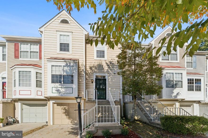 Beautifully maintained 2-bed, 2.5-bath townhome in an unbeatable location next to PG Community College and minutes from the Beltway and FedEx Field. This home is ideal for roommates or anyone seeking two spacious primary suites, offering comfort and privacy. The main level boasts hardwood floors with a combined living/dining area, a kitchen with a breakfast bar and table space, and custom Hunter Douglas window shades. The finished lower level features a cozy wood-burning fireplace, ceramic tile flooring, a laundry area, and access to the oversized garage, perfect for storage or accommodating larger vehicles. Upstairs, premium Berber carpet adds warmth and durability. With its versatile layout, upgraded finishes, and proximity to major commuter routes, shopping, dining, and entertainment options, this home delivers convenience, functionality, and style.