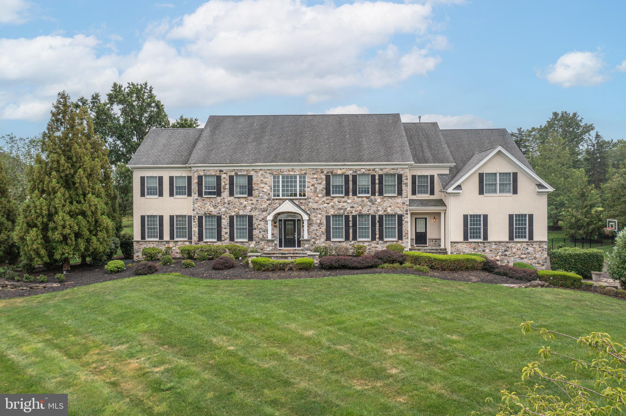 This custom residence in Matthew's Ridge offers an exceptional blend of luxury, comfort, and expansive floorplan. The home features a two story Foyer, formal Dining and Living rooms, Study with separate sitting room and built ins, large Conservatory, and a spectacular designer Kitchen with upgraded appliances, Atrium Breakfast Room with Palladian window and extensive workstation that features wine refrigeration and large center island. two story Family Room with floor to ceiling stone fireplace, 5 en-suite Bedrooms, including a luxurious primary suite with Sitting Room, 3 walks in closets, and a two sided fireplace. The walk-up lower level includes extensive exercise, games and entertaining space that includes wet bar. Other features include 10' ceiling height rich Brazilian cherry floors, elegant tray ceiling in Dining Room, Gas fireplaces, spacious four-car garage and state of the art mechanical systems.
Outdoors, the property is a true entertainer’s paradise. A custom cabana with its own bathroom, changing room, and surround sound system creates the perfect retreat beside the sparkling pool, complete with waterfalls and spa. Multiple refrigerators, a built-in bar, and a grilling station make hosting effortless, while the expansive deck and large grass lawn provides an ideal setting for gatherings and play space. Professionally landscaped grounds with sweeping long-distance views—an extraordinary property in a truly desirable community location, award winning Council Rock School District all within minutes from Newtown!