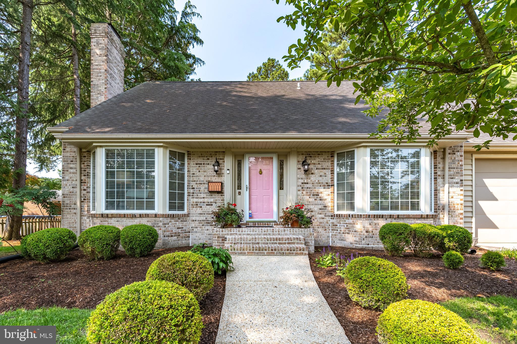Love at first sight is real, and you’ll feel it the moment you arrive at this elegant 3-bedroom, 2-bath home tucked into a beautifully landscaped setting. Filled with charm, warmth, and natural light, this home offers the ideal blend of style and comfort. Step into the welcoming living room, where a soaring cathedral ceiling, striking bay window, and cozy fireplace with brick insert create a bright and inviting atmosphere. Hardwood floors run throughout the main living areas, adding timeless appeal. A spacious loft overlooks the living room, offering the perfect space for a home office, hobby area, or reading retreat.
The finished basement is a true bonus - a peaceful escape featuring a wood-burning fireplace and custom built-in shelves, ideal for movie nights, quiet evenings, or entertaining guests. The kitchen features a pass-through to the sunroom, which is wrapped in windows and filled with light - perfect for casual dining, relaxing with a book, or enjoying the views of the tranquil backyard and patio. Both bathrooms have been thoughtfully updated, including a hallway bath with a dual sink vanity and a beautifully tiled tub/shower with a glass insert. The 2-car garage adds practicality, while the private backyard and serene patio invite outdoor enjoyment. Additional features include hot water heater (2023); air handler and all new ductwork (2024), and FLC-energized blown insulation for energy efficiency. It’s easy to fall in love - come see for yourself!