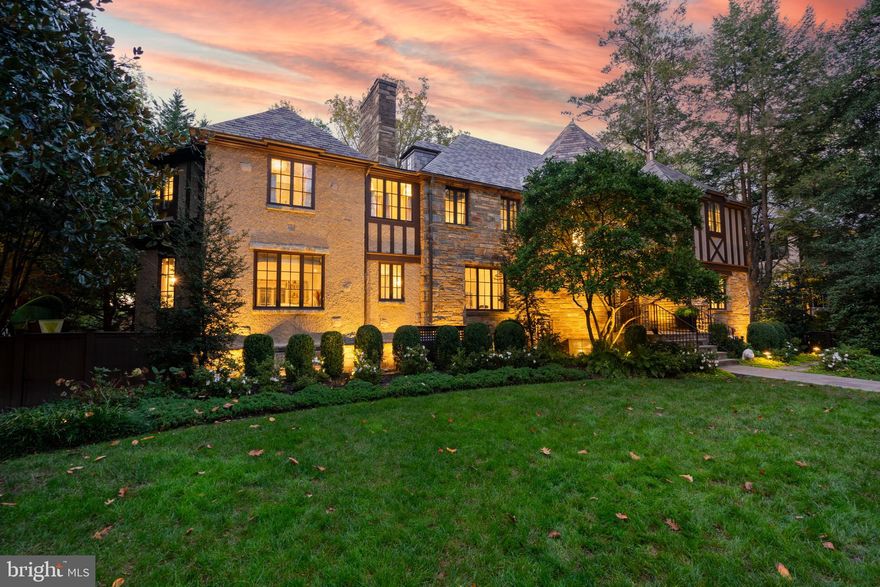 Wow!  Fabulous price adjustment!!  Nestled in the coveted Spring Valley neighborhood, this stately 1942 Tudor Revival has been thoughtfully renovated in 2023.  The result is a seamless blend of historic character and modern sophistication—more than just a home, it’s a living work of art designed for elegant living and effortless entertaining.

As you approach, the home’s iconic diamond-paned windows offer a glimpse into its rich architectural past. Step inside, and you’re immediately greeted by a harmonious fusion of classic craftsmanship and contemporary upgrades, elevating every space with purpose and grace.

The main level sets a tone of understated grandeur, with soaring 9+ foot ceilings and sun-drenched spaces throughout. The formal living room, framed by oversized windows and anchored by a wood-burning fireplace, invites both quiet moments and lively gatherings. The newly reimagined kitchen—part of the 2023 renovation by renowned architect Dale Overmyer, with construction by John Cecchi—is a showpiece designed for connection, featuring premium finishes and a seamless flow into the family room and dining area, all exuding warmth and sophistication.

The primary suite is a private sanctuary. With its own fireplace, dual walk-in and cedar closets, and a spa-inspired bath, it’s a retreat designed for true rejuvenation. The dual-sided bathroom is bathed in natural light from a skylight above the soaking tub and includes a private vanity and water closet.

Upstairs, each of the six bedrooms has its own story. Three bedrooms include a Jack-and-Jill bath arrangement—perfect for family living—while another features a private en suite. The light-filled Parisian-style suite offers its own full bath and private feel, ideal for long-term guests, an au pair, or an artist’s retreat.

The lower level is a world of its own, offering a flexible, self-contained living space with a private entrance, second kitchen, bedroom, recreation room, and two full baths. Whether used as an in-law suite, home gym, or creative studio, it’s designed to adapt to your lifestyle.

Outside, the home becomes a private resort. French doors lead to a spacious deck with a built-in grill and tree-lined views, perfect for hosting or unwinding. The fully fenced, professionally landscaped yard features irrigation, landscape lighting, and a heated pool with a remote-controlled cover—ideal for summer swims or relaxing on quiet Sundays.  A custom stone patio with a wood-burning fireplace provides the perfect backdrop for cozy evenings under the stars.

Additional features include a billiard room/library, built-in Sonos sound system, separate audio/visual room, dual laundry facilities, two garages, and a Ring security system—all set on a generous .33-acre lot.

Located in the sought-after Spring Valley community, this home offers the tranquility of suburban living with unmatched urban access. Enjoy brunch in the Palisades, short commutes to downtown DC or Tysons, and scenic walks through nearby parks and trails.

This is more than a home—it’s a story of legacy and reinvention, where every room reflects thoughtful design, enduring elegance, and purposeful living.