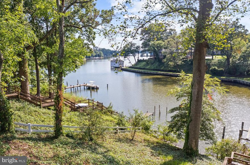 Newly renovated waterfront home with awe-inspiring water view across Crab Creek and out to the South River.  This spacious ranch home is move-in ready with plenty of space for a large family or lots of guests. With 0.78 acres of land including the enormous front yard, there is ample room for running around with both kids and pets. The waterside backyard provides multiple areas for enjoying the waterfront lifestyle. Relax on the rear deck or the screened porch with soaring ceiling while watching the activity on the water or head out yourself from your private pier with boat lift and multiple slips. With easy access to the South River and beyond the location is a dream for a boating enthusiast. Step inside the spacious foyer with views through the house to the water beyond.  The expanded Kitchen open to the dining room and wet bar is a chef's dream with large island, plenty of cabinets and counter space and high-end appliances. The sunken Living room with fireplace and adjoining screened porch are perfect for entertaining large or small gatherings. 3 bedrooms including the stunning Primary suite with walk-in closet and luxurious spa-like bathroom with freestanding soaking tub overlooking the amazing view. The upper level loft space has a multitude of uses including home office, play room, or hang out space.  Completing this must see property is the 2 car garage with conveniently located mudroom. Located just minutes away from everything the Annapolis area has to offer by car or by boat.  Don't let this opportunity pass you by. Welcome Home!