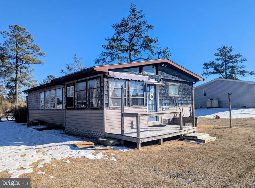 Great Beach House has room for your family and friends!  This modified single wide has over 1000 square feet of living space, a large Sunroom on the front, site built Living Room with Vaulted ceilings, one bedroom in the addition and three more bedrooms in the main home. The Central A/C was replaced in 2023, and the heat is electric.  Most of the furniture may convey with the home at buyer's option.  This home is situated on a nice size corner lot and offers a fenced in yard for your children and pets and a storage shed for all your beach needs! The home is spacious enough for several people to be comfortable and one bedroom has a private half bath.  The Sunroom, Living Room addition, front deck and one bedroom were built in 1989.  The lot rent is $787 per month which includes trash/recycle pick up.  Why not make this your year to enjoy the beach, salty air and sunshine!