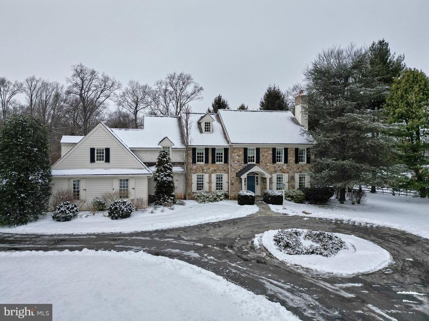 This beautiful, custom-built Colonial by E. B. Mahoney is situated on a flat, 1 ½ acre lot on the sought-after and quiet Beaumont Drive in Gladwyne.  It has mature plantings that promise you privacy all year round.  This home offers 4,400+ square ft of living space and a large, unfinished basement and attic that run the length of the house, just waiting for your desired finishes.  The house is extremely charming and refined with premium finishes including exquisite millwork throughout, beautiful random width and length floors on the first floor, open kitchen/family room, custom cabinets and built-ins, bright sunny rooms, a whole house Generac, and much more.
Enter the house through a copper roof covered door that leads to a gracious, two-story front hall with wainscotting, and a transverse staircase accented with continued custom wainscotting to the second floor.  To the right of the front door is a lovely living room with elongated windows and a handsomely adorned working, wood-burning fireplace enclosed in exceptional colonial millwork.  Its elongated windows provide views of the property and maximum light to the room.  Beyond the living room are French doors to the study.  The study has wonderful natural light, beautiful views of the back yard and access to the family room/eat-in kitchen area. Under the stairs is a formal powder room.
To the left of the front door is the generously sized, formal dining room that flows into the eat-in gourmet kitchen.  The gourmet kitchen has custom cabinetry, black soapstone counters, double oven and high-end appliances.  There is an island with for working and eating and an additional eat-in dining area with sliders to a fabulous, flagstone terrace with a sitting wall and a perfectly flat backyard with split-railed and deer fencing.  It is a wonderful place for enjoying quiet time or for entertaining. 
The kitchens eat-in dining area flows into the two-story family room with large, beautiful windows, a custom cabinet wet bar, a wall of built-ins, and a stone wall surrounding the fireplace, serving as a focal point for the room.  The room provides access to the study from the living room.  On the other side of the kitchen is a wonderful mudroom/laundry-utility area with a large sink, stone floors, and custom wood paneled walls.  It affords good storage and includes doors to the basement with Biltco egress door, the 3-car attached garage, the backyard, and access to the back stairs to the second floor.
There are 5 generous, light filled bedrooms, three ensuite, and 4 bathrooms on the second floor.  The primary ensuite is large, with custom-designed marble countertops, beautiful walnut cabinetry, double sinks, a spacious glass, marble tiled shower, and a cabinetry-enclosed bathtub.  The main ensuite also includes a large, walk-in closet.  Down the hall, you will find another ensuite bedroom with a walk-in closet and laundry chute and 2 additional bedrooms with walk-in closets that share a marble countertop, double sink with storage, and tub/shower combo bathroom.  At the end of the hall, and at the top of the back steps, is the expansive, 3rd ensuite bedroom with a sitting area, built-in shelving, window seat and large closet.
This home’s location is the best.  The neighborhood is easily walkable to the historic Village of Gladwyne with its horse trails, park, library, shops, elementary school, and restaurants.  It is near state roads, public transportation, and fabulous public and private schools.  It’s a must-see!!!