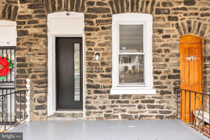 Stone-front home with a welcoming covered porch and hardwood floors throughout. The first floor features a beautiful kitchen with an island and stone countertops, a spacious living room with recessed lighting, plus a laundry room and full bathroom for added convenience. The second floor offers a generous primary bedroom and an oversized full bathroom complete with a frameless glass shower and a freestanding soaking tub. The third floor includes two spacious bedrooms, each with ample closet space.  Out back, enjoy a large rear deck and yard—perfect for relaxing or entertaining. All you have to do is move in and unpack. Conveniently located within walking distance to local restaurants and the train.