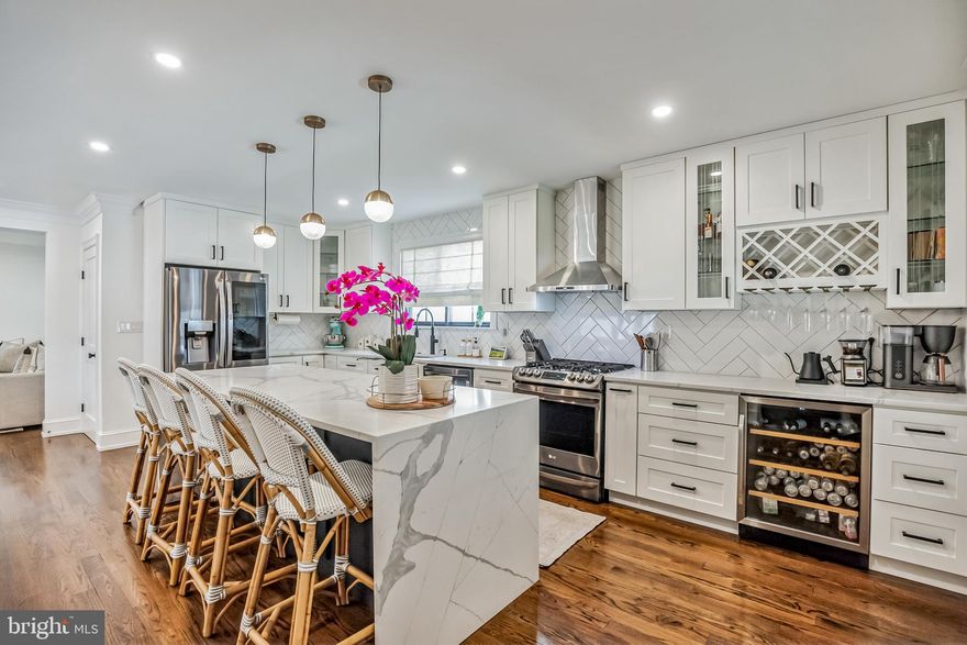 This meticulously maintained 5-bedroom, 3.5-bath single-family home in Havertown offers the perfect blend of modern luxury and classic comfort. Pull into the convenience of a private driveway, eliminating the nuance of shared parking. Step inside and be greeted by an open living area featuring a floor-to-ceiling gas fireplace, perfect for cozy nights in. The gourmet kitchen boasts Calacatta countertops, a waterfall island, and beautifully refinished hardwoods that flow throughout the entire first floor. This expansive home offers over 3,500 sq ft of finished living space. The finished basement provides a versatile space for a playroom, media room, or additional living area. Unwind and entertain in style on the expansive back patio with wood-planked ceilings, extensive hardscaping, and a projection screen - perfect for summer cookouts or relaxing evenings under the stars. This home boasts a larger-than-most backyard, ideal for creating your own private oasis. There is a finished and heated 220 sq ft space in the back of the garage that provides the perfect solution for remote work, working out, or hobbies. The garage has an electric vehicle charging station. The luxurious primary suite features a spa-like bathroom with radiant heat floors and large walk-in closets. All three bathrooms have heated flooring. Three additional bedrooms on the second and third floors provide ample space for family or guests. Everything in this home is less than three years old, including all systems and the roof, offering peace of mind for years to come. Located within walking distance of Havertown's top-rated schools, charming shops, and vibrant restaurants, this home offers the best of both worlds. The list is long, but Al Pastor, Crossbar, Kettle, Koffmeyer's, Brick & Brew, and a terrific WaWa.