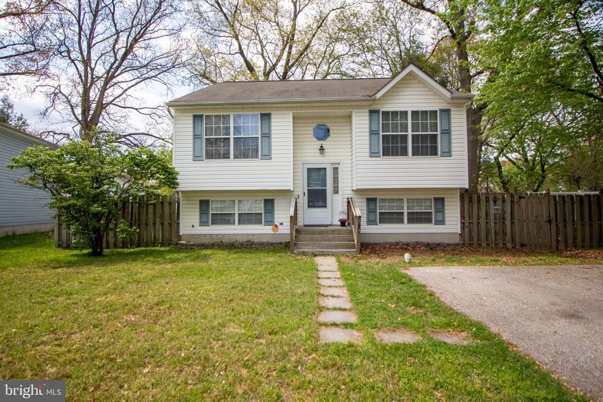 Welcome to this beautiful split foyer home in Glen Burnie Heights. A spacious front lawn welcomes you as you pull into the paved driveway. You'll have plenty of room for you and your family to grow with 4 bedrooms, 3 bathrooms, and 1,064 sq ft of space. Walk up to a light and bright open space layout with vaulted ceilings and hardwood floors flowing throughout the main level. Entertain guests easily in the dining room with Tiffany inspired stained glass pendant lighting. The spacious kitchen features plenty of counter space, cabinet space, and a deep sink with side detachable faucet, and window view. Also features all stainless steel appliances, including a double door fridge with ice maker. Unwind in the family room with cooling ceiling fan. Retreat to the primary bedroom on the same level with en-suite bathroom featuring a tub/shower combo. Two bedrooms and a full size hall bath complete the level. The lower level features plush carpeting and an additional living space. Also includes the 4th bedroom and 3rd full bath, perfect for guest or in-law suite. Relax in your fenced in backyard and the brick patio - perfect for a summertime BBQ! Located within minutes of all major highways, 20- 25 minutes from Downtown Baltimore, Annapolis, and Columbia, and in close proximity to BWI, NSA, Ft Meade, and Northrup Grumman. This home is a perfect central location with convenience to shopping, dining, entertainment, parks and activities. Do not miss out on this one!