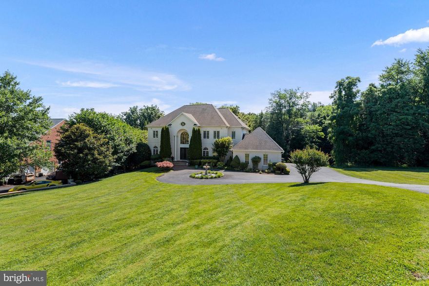 Wow! Sun-splashed and beautifully maintained custom-built brick colonial on a 1.2-acre homesite backing to a state-protected bird sanctuary. With over $120,000 of improvements and more than 7,600 square feet of living space, this home features an open floor plan with spacious rooms and a beautiful outdoor area making it ideal for everyday living and entertaining. Step through the dramatic double-door entrance, into the magnificent marble foyer with a stunning chandelier and imperial staircase, leading to spaces where you can entertain on a grand scale, or enjoy everyday living. Nearly every beautifully-appointed room is lined with floor-to-ceiling windows, including a formal dining room, living room, great room, and office - all with custom window treatments.  More than $80k went into designing the beautifully appointed kitchen which includes quality custom cabinetry, granite countertops, a large center island, high-end stainless steel appliances, a butler’s pantry, and office space. The sun-filled breakfast room provides additional seating with views and access to the expansive tree-lined yard and wooded bird sanctuary. 
The upper level hosts four generously sized bedrooms, all with ensuite baths and ample closet space.  The primary suite will be your quiet retreat with a private balcony and a large walk-in closet. The spacious and light-filled primary bath has a soaking tub, separate shower, and double vanity. The walk-out lower level provides plenty of additional living space that includes the fifth bedroom, a full bath, a large recreation room with a wood-burning fireplace, a club room with a wet bar, and space that can be maximized with a combination of an office, media room, exercise space, or game room. This home has a spacious three-car side load garage with a mudroom entrance and a bedroom-level laundry room to keep everyone organized. 
Enjoy the convenient location of this home, centrally located near major commuter routes and an international airport while having the luxury of privacy and parkland views. Tysons and Reston are both nearby, with hip restaurant scenes, wonderful shopping at Tysons Galleria, and local parks with trails for walking/biking. This home is in the Langley School Pyramid.