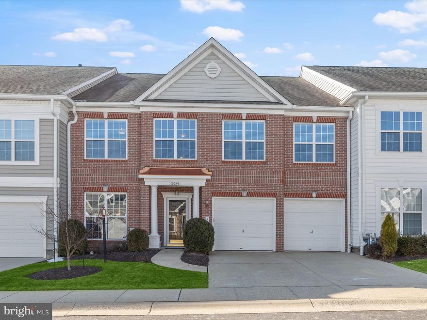 OFFER Deadline: Sunday 3/2 at 3 PM. Stunning brick-front villa offering over 5,000 square feet of meticulously designed living space, featuring soaring ceilings, elegant finishes, and thoughtful upgrades throughout. Nestled in a sought-after 55+ community with top-tier amenities—including a renovated clubhouse, fitness center, party room, outdoor patio, pool, and scenic walking paths—this exceptional home blends sophistication with comfort.
Step inside to a grand foyer adorned with rich hardwood flooring and crown molding, setting the stage for the refined details found throughout the home. A private study, complete with built-in bookcases and a double door entry, provides a quiet retreat. The open-concept main level showcases a seamless flow between the living and dining areas, with a two-story ceiling and a striking dual-sided fireplace that also warms the adjacent sunroom. Pendant lighting adds a touch of elegance to the dining area, while custom moldings and cohesive fixtures elevate the space. Designed for both function and style, the gourmet kitchen is a dream, featuring 42-inch cabinetry with undermount lighting and roll-out shelves, granite countertops, a tile backsplash, and sleek appliances, including a double wall oven and gas cooktop. A bright breakfast room with a soaring ceiling and sliding glass doors leads to one of two inviting patios—perfect for morning coffee or al fresco dining. This updated kitchen seamlessly blends contemporary convenience with timeless elegance. The main-level primary suite is a true retreat, boasting a walk-in closet with a custom organization system and a spa-like en-suite bath with a double vanity and a tiled shower with a built-in bench. Upstairs, a spacious loft overlooks the main level, offering a versatile space for lounging. The upper-level bedroom suite is equally impressive, with a sitting area, two closets, a linen closet, and an en-suite bath featuring a jetted soaking tub, a separate shower, and a double vanity. The upper-level carpet was replaced in 2025, ensuring fresh, updated comfort in the home’s private quarters. Two additional bedrooms share a well-appointed dual-entry bath with double sinks. The fully finished lower level extends the home’s incredible living space, featuring a generous recreation room with integrated speaker system and walkout stairs, a dedicated workshop with luxury vinyl plank flooring, a full bath, and an expansive storage room. Outdoor living is just as impressive, with two patios—one composite with custom built-in bench seating—offering the perfect setting for relaxation or entertaining with the backdrop of beautiful blooming trees in the spring. Completing this exceptional home is a two-car garage and ample storage throughout.
This impeccably maintained, move-in-ready residence is a must-see, offering the perfect blend of luxury, convenience, and community living. Property Updates: Upper level carpeting, Furnace/AC Unit, Water Heater, and more!