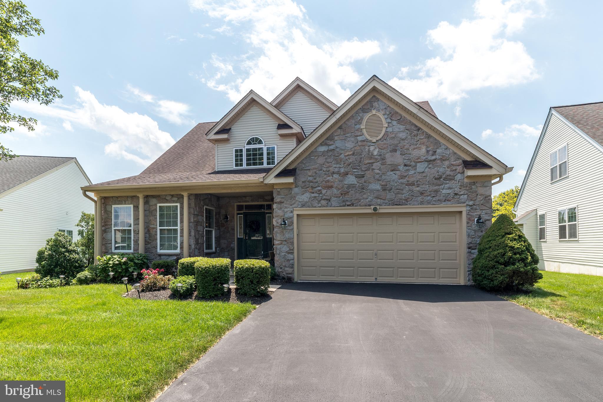 LOCATION, LOCATION, LOCATION! Welcome to this beautifully maintained and uniquely charming Doyle model home located in the highly desirable Legacy Oaks at Warrington, a premier 55+ Gold Star community. Featuring stunning curb appeal with an elegant stone front and nestled on a premium lot offering serene views of mature landscaping and the community walking path, this home truly stands out. Step onto the epoxy-coated front walkway and into a grand 2-story Foyer with hardwood floors and soaring 19’ ceilings, setting the tone for the warmth and elegance found throughout. The hardwood flooring continues into the formal Living and Dining Rooms as well as the Powder Room, creating a seamless flow perfect for entertaining. The spacious Kitchen is a chef’s delight with a sun-filled bay window, tile flooring, 42" white cabinetry, a generous pantry, newer stainless steel appliances, and a cozy breakfast area. Step out through sliding glass doors onto the private Trex deck—ideal for morning coffee or al fresco dining. Open to the kitchen, the cathedral-ceilinged Family Room offers abundant natural light, a dramatic wall of windows, and a gas fireplace with blower and built-in audio system—perfect for relaxing or entertaining. The main-level Primary Suite offers a peaceful retreat with two walk-in closets, a linen closet, and a luxurious en-suite bath featuring a jetted soaking tub and double vanities. Upstairs, you’ll find two additional bedrooms, each with ceiling fans, a full hall bath with walk-in shower and large linen closet. The unfinished basement provides ample space for storage or future finishing. Additional features include: Newer Amana HVAC (2018) and water heater (2018), Central vacuum system, Multi-room audio system, Security system, Epoxy-coated garage with side entrance door & nook for workbench, Sump pump and Water Commander backup system, Main floor laundry with utility sink and extra cabinetry. Pride of ownership is evident throughout this meticulously cared-for home. Enjoy an active lifestyle with a vibrant community calendar full of social and recreational events, all while being close to shopping, dining, and everyday conveniences. Don’t miss the opportunity to own this one-of-a-kind home in one of Bucks County’s most sought-after active adult communities!