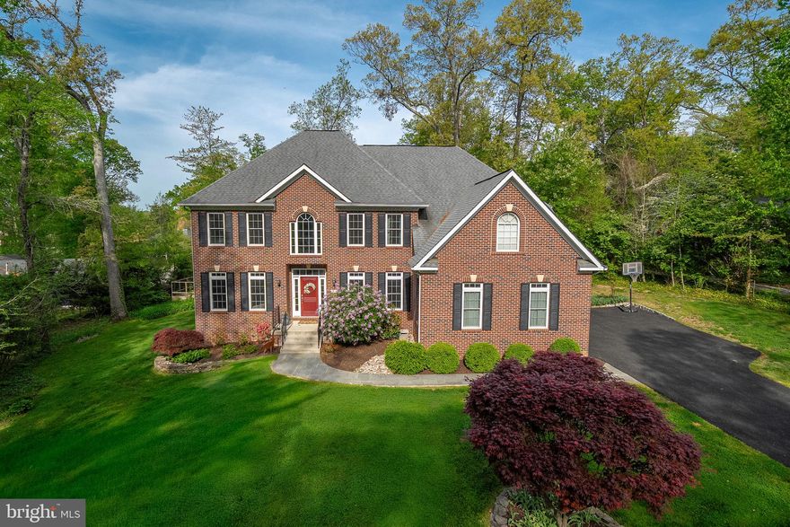 Welcome to a truly refined offering in the heart of Fort Hunt where timeless design, thoughtful upgrades, and a warm, family-friendly lifestyle come together effortlessly.

Built in 2015 by NDI as part of their coveted Estate Series, this exceptional residence has been beautifully enhanced over time, blending quality craftsmanship with modern livability. Sited on a picturesque half-acre along a quiet, tree-lined street, the setting is as inviting as the home itself, just minutes to Hollin Hall Shopping Center and within the beloved Waynewood Elementary district.

Inside, nearly 5,600 finished square feet unfold across three thoughtfully designed levels. The main level balances elegance and ease, featuring formal living and dining rooms for special gatherings, while the heart of the home is the open-concept kitchen and dramatic two-story family room—anchored by a striking stacked stone Astria gas fireplace. Whether hosting holidays or enjoying a cozy evening in, this space was designed to bring people together. A rare main-level bedroom offers flexibility for guests, multigenerational living, or a private office, while both a front and rear staircase add everyday convenience and charm.

Upstairs, the primary suite is a true retreat, complete with a sitting room and a custom-designed walk-in closet that feels as elevated as it is functional. Three additional bedrooms include a well-appointed shared bath and a private ensuite, offering comfort and space for everyone.

The recently finished lower level expands the home’s versatility with a recreation room, media space, gym, game area, full bath, and an additional legal bedroom, perfect for guests or extended stays.
Outdoor living is just as inviting, with a Trex deck overlooking mature landscaping and a spacious backyard ready for play, entertaining, or quiet evenings under the trees.

Additional highlights include a three-car garage with EV-ready capability and a functional mudroom/laundry area just off the garage, designed for the rhythm of daily life.

Located steps to the GW Parkway, bike paths, walking trails, parks, and the Potomac River.  Minutes from Old Town Alexandria and Mount Vernon, Fort Belvoir, The Pentagon, Huntington Metro, National Airport, and DC. 

This is more than a home, it’s a place to grow, gather, and create lasting memories in one of Alexandria’s most cherished communities.