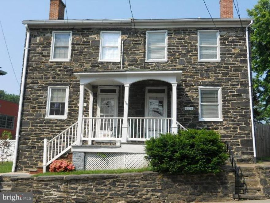 Historic 1847 stone duplex in Clipper Mill totally renovated in 2006! Two spacious bedrooms plus a loft!   State of the art kitchen and bathrooms, recessed lighting, replacement windows, combined with the old world charm of gleaming wood floors, interior stone walls, and wood burning fireplace!  Fully fenced side yard.  Parking space in the rear!  Close to light rail and Clipper Mill shops!