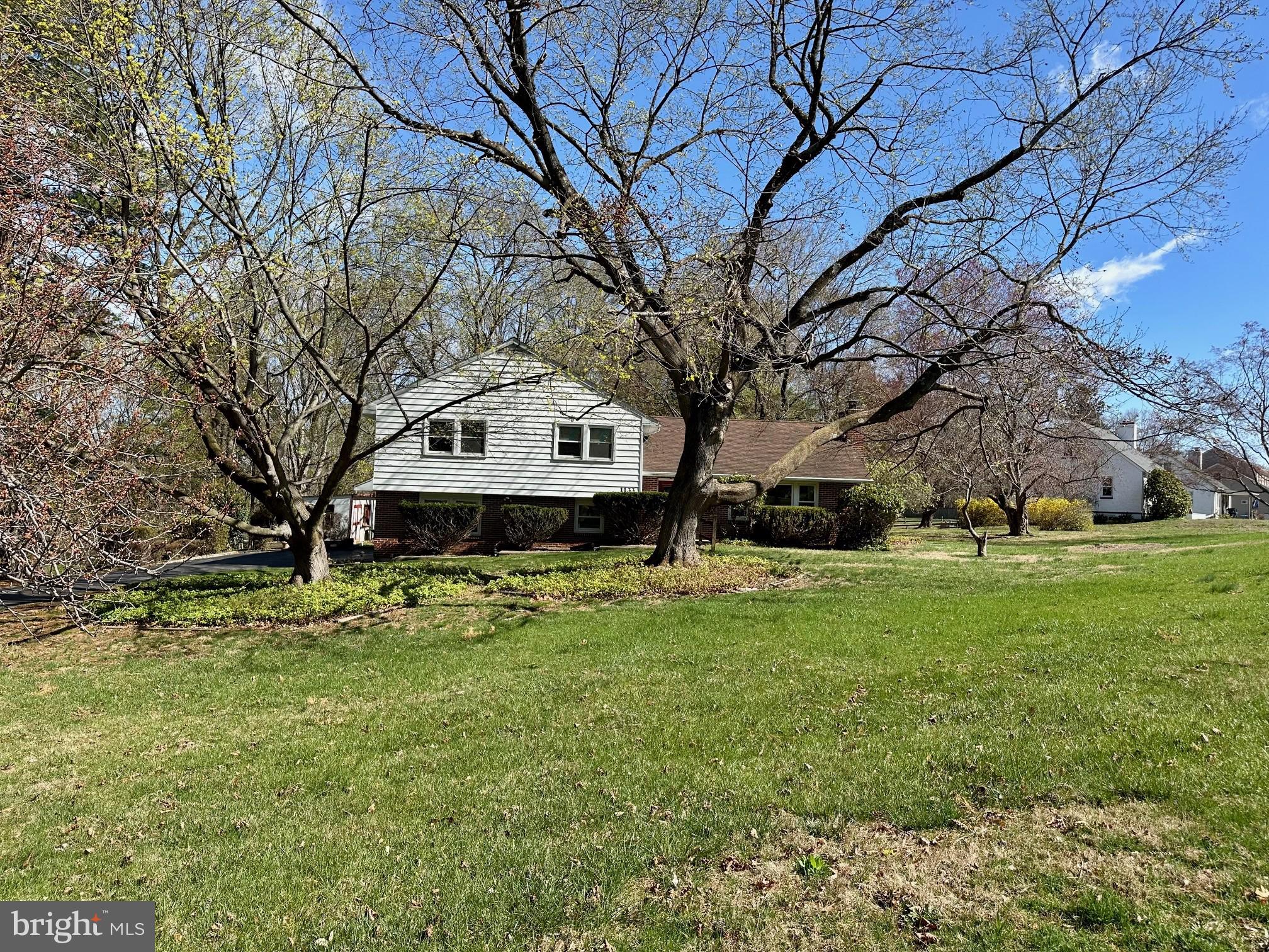 This classic West Chester split-level home offers spacious living and an exceptional location. Featuring four bedrooms and two full bathrooms, this property sits on a large, flat lot with a fantastic yard, perfect for outdoor activities. A unique opportunity to own a 1.2 acre West Chester lot. With low taxes, no HOA, and a prime location near the West Chester borough and Exton, it’s an ideal find for those looking for convenience and potential. The entryway welcomes you with a designer door and a stylish tile floor. The generous living room boasts a wood-burning stove with a stone mantle and a large bay window, filling the space with natural light. Adjacent to the living room is an elegant, good-sized dining room, perfect for family meals or entertaining guests. The large kitchen offers upgraded cabinetry, a pantry for extra storage, a ceiling fan for added comfort, and direct access to the backyard. A great space for meal prep and family gatherings. The master bedroom features its own private full bath, and three additional bedrooms provide ample space for family or guests. The large lower level/ground-level family room has French doors that open to the outdoor patio area, making it ideal for indoor/outdoor living. A spacious laundry room, also on the lower level, includes a large laundry tub sink for added functionality. The home also boasts a large, unfinished basement that houses all utilities and offers plenty of storage space. Additional features include a two-car attached garage, and central air. Outside, enjoy a flat, usable yard with an outdoor shed and a large driveway offering plenty of off-street parking. This home is truly a diamond in the rough, ready for your personal touch to make it shine. Don’t miss the opportunity to make this private spacious home yours— Showings will begin on Sunday April 13th with an afternoon open house from 12-2 allowing you to see it without an appointment.