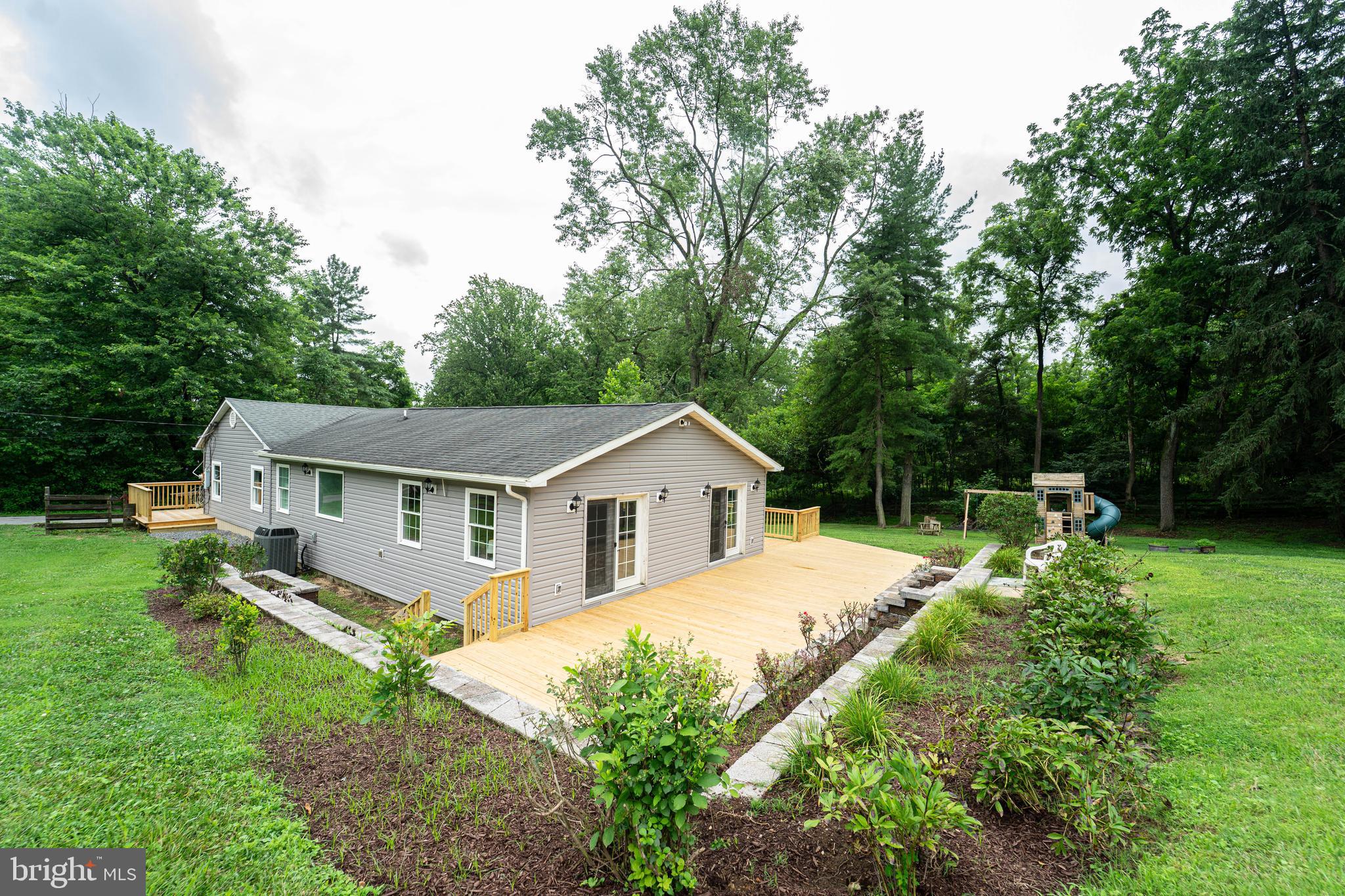 OPEN SUNDAY 7/27 from 12-2pm. Tucked away on well over an acre of scenic, private land, this beautifully updated rancher offers the perfect blend of modern luxury and peaceful seclusion. Just minutes from the state park, this home feels like a retreat while still being close to everything you need.
Step inside to discover a thoughtfully renovated interior featuring a stunning new kitchen with custom cabinetry, sleek countertops, and stainless steel appliances. The bathrooms have been completely updated with stylish finishes and spa-like touches. The spacious master suite offers a peaceful escape with plenty of natural light and a beautifully updated en-suite bath.
Gleaming hardwood floors flow throughout the home, and a large laundry room adds both function and convenience. Step outside onto the brand-new deck and take in the views of the expansive, flat backyard — perfect for entertaining, playing, or simply enjoying the tranquility of nature.
This one-of-a-kind property offers the space, style, and serenity you've been searching for. Don't miss the chance to make it yours!