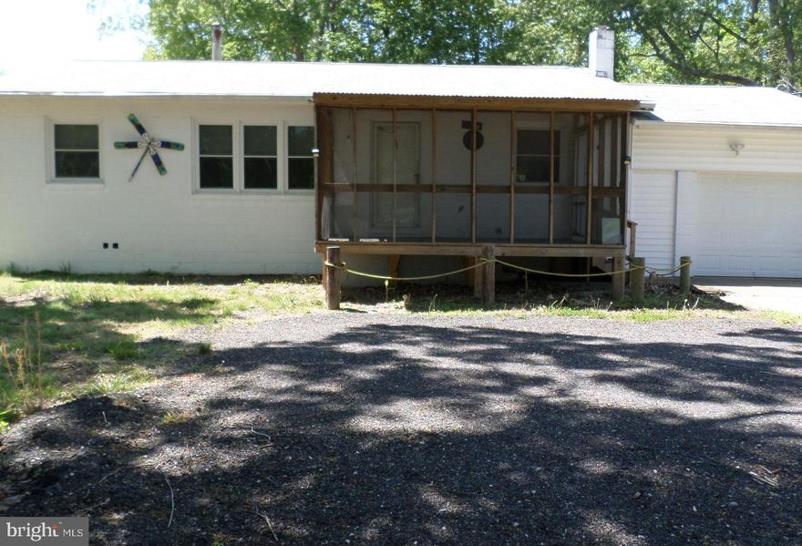 Enjoy a like-new home recently updated with new flooring, 2 updated bathrooms, and some painting. The roof and windows were replaced in 2019, and a new HVAC system was installed in 2017. The oversized kitchen offers a buffet bar with a sink and cabinets. You'll enjoy the comfort of lounging on the new 8 x 12 screened-in front porch. The home has an attached one-car garage, a separate detached 1-car garage with storage space, and a 6-car driveway, offering ample space for vehicles. Both garages have electricity and workshop space. The large yard provides plenty of space for outdoor living, gardening, and entertaining. Also includes a 23" camera TV and 3 televisions (one 55" big screen). Schedule a tour today!