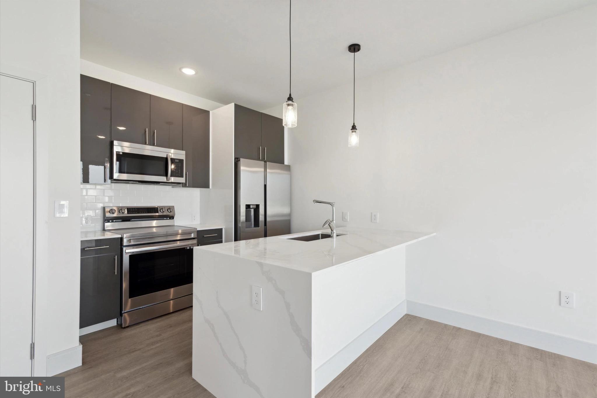 Discover 1221 E Fletcher St, a newly constructed haven boasting 47 stunning apartments. Choose from diverse floor plans, including studio, 1 and 2-bedroom options, some featuring private outdoor spaces. Enjoy the convenience of in-unit laundry, stainless steel appliances, and high-end finishes. Nestled in the sought-after Fishtown neighborhood, you'll find yourself within walking distance of numerous bars, restaurants, coffee shops, parks, and more. Welcome home to contemporary living at its finest. Unit 406 embraces an abundance of natural light through its expansive windows. The central kitchen island effortlessly becomes the heart of gatherings, complemented by the adjacent oversized bedroom featuring a beautifully spacious organized closet.
Promotions: Price is effective rent after a concession amortized on a $1700 lease price