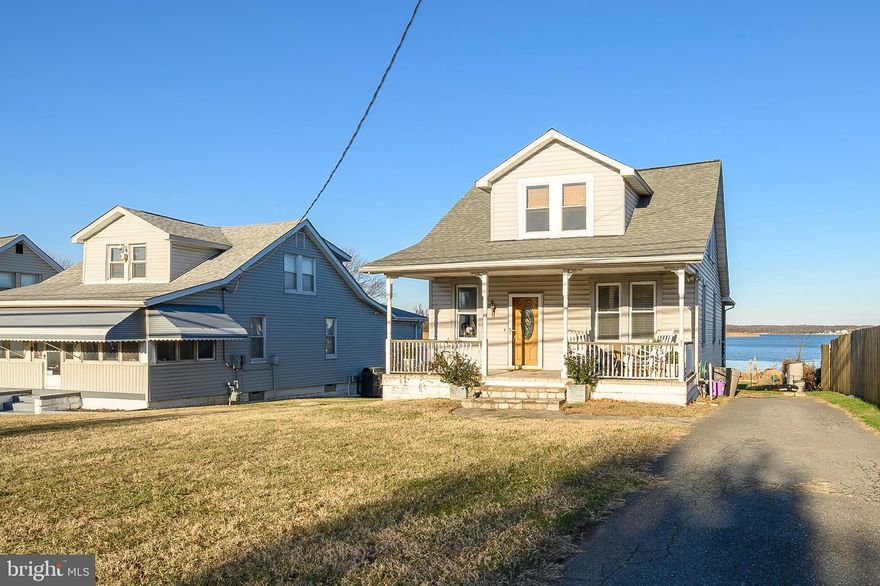 Enjoy the picturesque direct waterfront views off the enclosed screened porch with a 100 foot pier and 50 feet of water frontage. The new bulk head and updated pier is perfect for boating, kayaking, fishing and crabbing. This great home offers an updated kitchen with appliances that are less than 4 years old. There is a primary bedroom and full bathroom on the main level. Some of the flooring was redone in the past 3 years. The upper level has a full bathroom and 2 bedrooms each having their own walk-in closet.  This is a level lot with a fenced back yard and close to local amenities. Make this captivating view yours today. Selling AS IS. No repairs will be made by the seller.