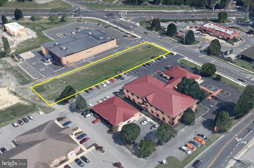 .56 Commercial acres. Existing entrance off Parsons Road. Driveway in place. Site plan approved for 1800 SF building and 2400 SF building. Fees paid for traffic light.