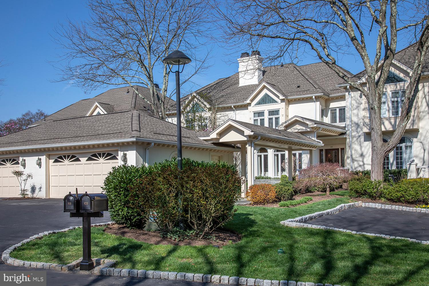 The best of Wrenfield awaits you at 918 Exeter Crest, an exquisite, fully renovated townhouse with a breathtaking view of the pond, lush greenery and natural wildlife! This exceptional home is truly unique, with a large private front yard oasis featuring new shrubs, lighting & stone sitting wall, a striking covered flagstone walkway to the main entrance, wide drive for parking, and 2-car detached garage complete with a total shelving system and 2 electric car chargers. Also thoughtfully installed is a 500-gallon propane tank for gas and energy efficiency, and a whole-house backup generator in the event of a power outage. Here you will enjoy a luxurious carefree lifestyle in an exclusive gated community, where impeccable grounds and exterior maintenance are tended to for you (included in the HOA fee of $1370/month). Gorgeous interiors liken single-family living, with 4 spacious, immaculate stories graced by high-end finishes and amenities, even an elevator that stops at the lower through 2nd floors. Owners did extensive renovations creating a modern open flow on the main level with an all-new kitchen, new den, new powder room and new fireplaces. An elegant entry hall with wood floors opens to a generous living space with striking fireplace & wall of windows for brilliant light. The dining room is also perfect for entertaining, with a seamless connection to the stunning renovated kitchen. Sparkling white chefs quarters are top of the line with sleek cabinetry, quartzite counters, backsplash & island, separate wet bar, and premium Miele & Sub-Zero appliances. A sun-drenched conservatory-style breakfast area opens to the outdoor deck through sliding glass doors for coffee, cocktails, alfresco dining, and beautiful views of the community fountain & pond. The cozy family room enriched by a gas fireplace and built-ins has patio access as well. The 2nd story has been tastefully redone with new hardwoods, a new den/office, laundry room, new primary suite bath with steam shower & radiant heat, and new outfitted closets. One additional bedroom and a new secondary full bath enhance the comfort. Level 3 offers a fabulous new suite with huge bedroom and bath. An ideal hangout, the renovated basement has a game room, bar, theater area, fireplace, exercise room, bedroom & full bath, plus doors to a lower patio. Storage abounds & utilities are new including HVAC. Turnkey living in a coveted location, with 24-hour security in prime Northside Villanova.