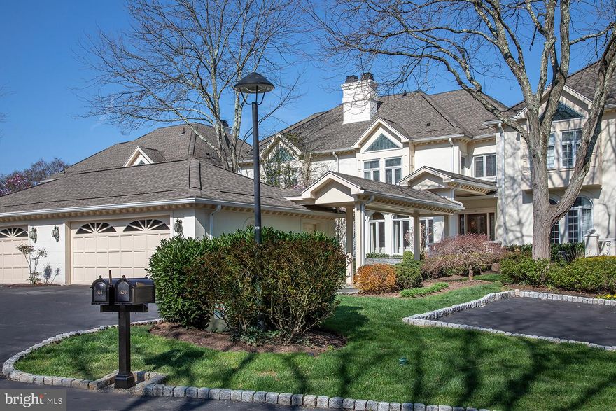 The best of Wrenfield awaits you at 918 Exeter Crest, an exquisite, fully renovated townhouse with a breathtaking view of the pond, lush greenery and natural wildlife! This exceptional home is truly unique, with a large private front yard oasis featuring new shrubs, lighting & stone sitting wall, a striking covered flagstone walkway to the main entrance, wide drive for parking, and 2-car detached garage complete with a total shelving system and 2 electric car chargers. Also thoughtfully installed is a 500-gallon propane tank for gas and energy efficiency, and a whole-house backup generator in the event of a power outage.  Here you will enjoy a luxurious carefree lifestyle in an exclusive gated community, where impeccable grounds and exterior maintenance are tended to for you (included in the HOA fee of $1370/month). Gorgeous interiors liken single-family living, with 4 spacious, immaculate stories graced by high-end finishes and amenities, even an elevator that stops at the lower through 2nd floors.   Owners did extensive renovations creating a modern open flow on the main level with an all-new kitchen, new den, new powder room and new fireplaces. An elegant entry hall with wood floors opens to a generous living space with striking fireplace & wall of windows for brilliant light. The dining room is also perfect for entertaining, with a seamless connection to the stunning renovated kitchen. Sparkling white chefs quarters are top of the line with sleek cabinetry, quartzite counters, backsplash & island, separate wet bar, and premium Miele & Sub-Zero appliances. A sun-drenched conservatory-style breakfast area opens to the outdoor deck through sliding glass doors for coffee, cocktails, alfresco dining, and beautiful views of the community fountain & pond. The cozy family room enriched by a gas fireplace and built-ins has patio access as well.  The 2nd story has been tastefully redone with new hardwoods, a new den/office, laundry room, new primary suite bath with steam shower & radiant heat, and new outfitted closets. One additional bedroom and a new secondary full bath enhance the comfort. Level 3 offers a fabulous new suite with huge bedroom and bath. An ideal hangout, the renovated basement has a game room, bar, theater area, fireplace, exercise room, bedroom & full bath, plus doors to a lower patio. Storage abounds & utilities are new including HVAC. Turnkey living in a coveted location, with 24-hour security in prime Northside Villanova.