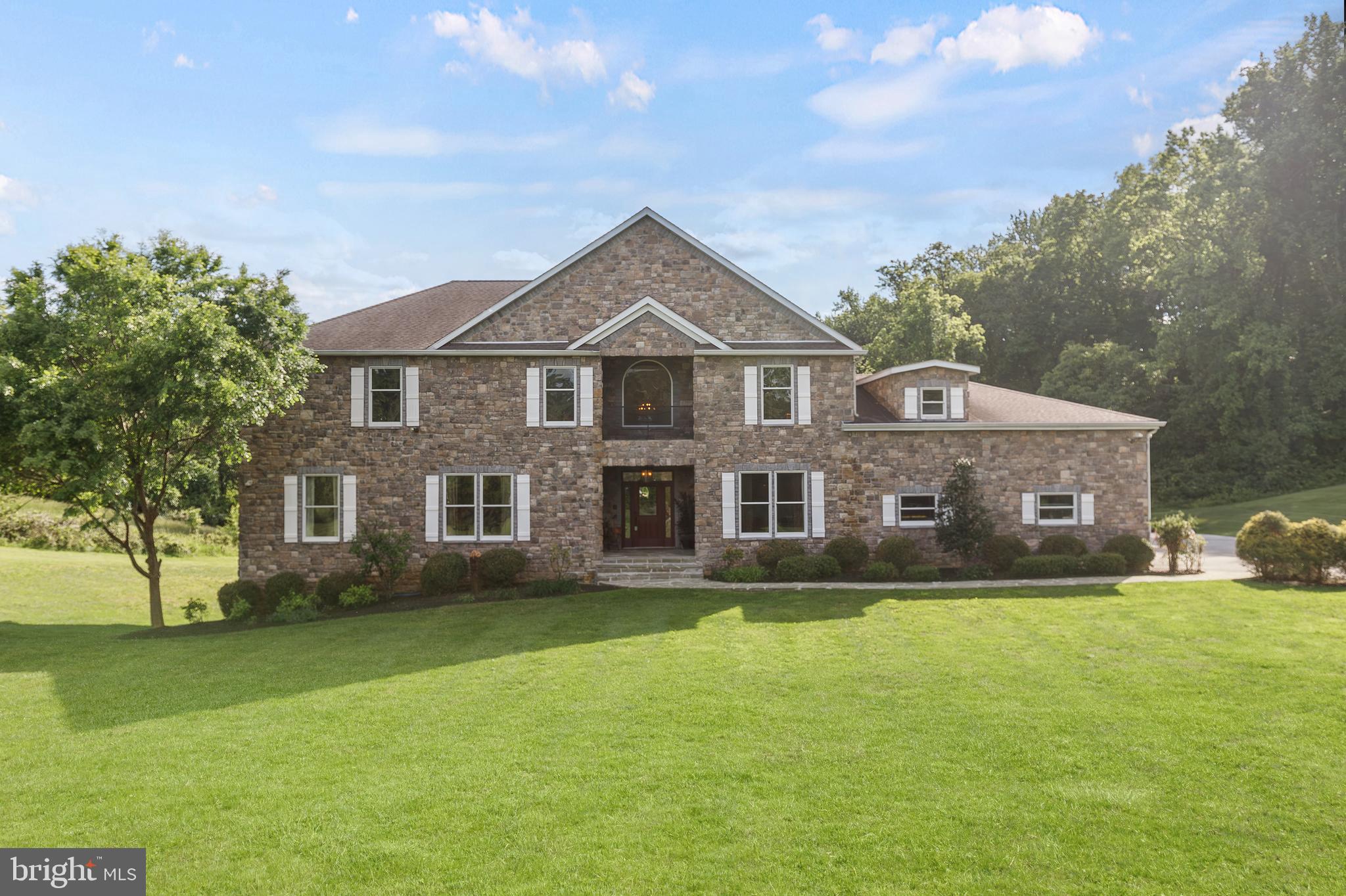A home where traditional design meets modern flair! The design features a series of angular, geometric shapes that create a dynamic and visually interesting structure! 5 BR including the separate apartment over the garage. The One of a kind lot/location bordered by trees offers privacy and tranquility as well as convenience to shopping and entertainment. The covered deck and expansive flagstone patio are perfect for entertaining. The open floor plan includes 10 foot ceilings on the main level and loads of natural light. The main level and the second floor have den/offices for those working from home. All BRs have ensuite baths and walk in closets. There is a complete apartment over the garage with a private entrance off the patio in back (yes there are steps). The apartment includes LR/DR/Kitchen, a bedroom and a full bath and laundry. The red door off the back patio is the separate entrance to the apartment. The huge exercise room in the lower level will hold any equipment you desire! Don't forget the driving range and detached garage/workshop with a car lift. Overall the home is a blend of comfort and convenience with features to discover in every corner!