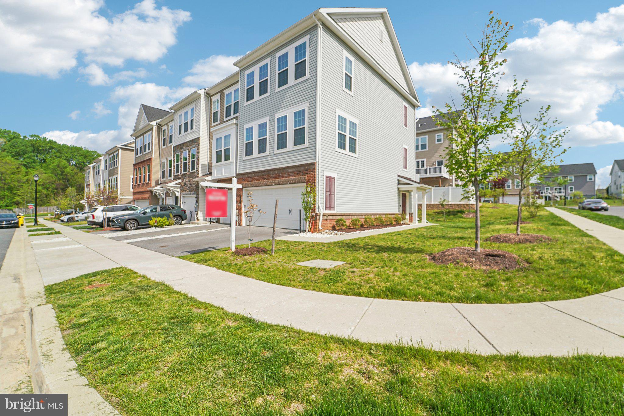 This modern three-level, 2-car garage townhome, built in 2020, is ready for its new owners. Immaculately maintained, this home features spacious rooms, a flexible living space, a contemporary kitchen, and a large deck. Located in a thoughtfully designed planned community, residents enjoy access to three pools (with available guest passes) and a clubhouse with 24-hour gym access. Positioned as an end unit, this home offers convenient guest parking and ample natural surroundings for added privacy.
Enter through the main entrance or the garage to find the entry level, which includes a customizable flex space perfect for a secondary living area, office, or home gym. This level also features a rough-in for a future three-piece bath, complete with a pre-vented exhaust fan. The main level offers an expansive living area, dining space, and a modern kitchen, with seamless access to a low-maintenance deck for outdoor living. A conveniently located half bath is also on this level.
The upper level completes this home with a generously sized owner's suite, plenty of closet space, modern fixtures, and a strategically placed washer and dryer for convenience. Homes in this desirable community are rarely available, so don't miss your chance to make this one your own. Your opportunity awaits!
