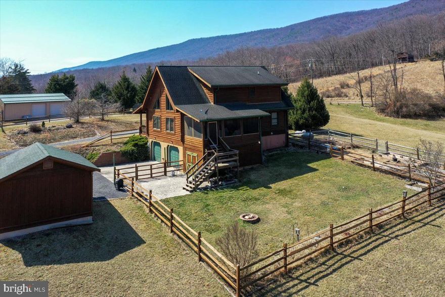 Escape to this well-maintained,  4-bedroom, 2-bathroom cabin, perfectly situated on 6.38 acres in scenic Baker, WV. This exceptional property offers breathtaking views of the rugged West Virginia mountains, paired with the convenience of a level and usable yard, making it an ideal retreat. 
Indoor Features: stunning wood floors, an open floor plan, and large windows fitted with UV film to preserve your panoramic mountain views. Kitchen is generously sized with ample counter space, perfect for meal prep and entertaining. Main Floor Comfort: Includes two bedrooms and a shared bathroom for convenient living. Screened-In Porch: Accessible from the dining area, offering spectacular views and a serene atmosphere. Private Primary Suite: Located upstairs with a cozy loft sitting area overlooking the main floor, providing an inviting space to relax while enjoying mountain vistas. Finished Lower Level: Features a bonus room/bedroom, a spacious laundry area, and a two-car garage for added convenience. Outdoor Features: Energy Efficient: Equipped with solar panels, keeping the electric bill around just $5 per month. The home is also wired for a gas-powered generator. Gardener’s Paradise: Includes eight apple trees, blueberries, raspberries, a fenced-in 20x60 ft raised-bed garden, and a mature( 3 years) asparagus patch. Ample Storage: Shed with a dedicated cellar space for canned goods, storage, and room for gardening tools and a push mower. Natural Beauty: A charming frog pond and a seasonal stream enhance the peaceful ambiance of the property. 30 minutes to Romney, WV – Access to hospital services and everyday amenities. 20 minutes to Lost River and to Wardensville, WV – Enjoy an organic local garden market, quaint shops, and dining experiences.  A little over 1 hour to Thomas/Davis, WV and just over 2 hours from NOVA & DC – An ideal mountain escape from city life. This is a rare opportunity to own a tranquil and picturesque mountain retreat. Schedule a showing today—you won’t want to leave!