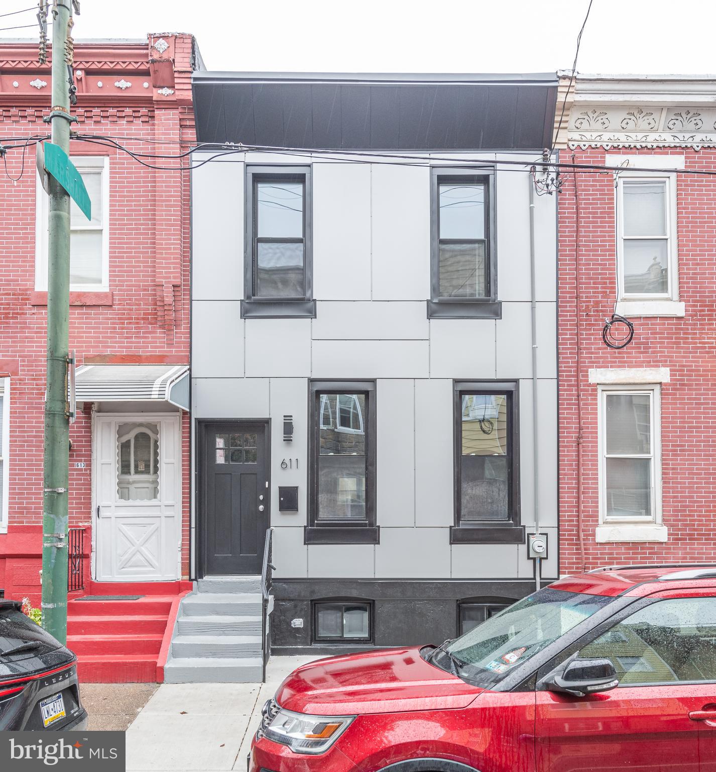 Discover this STUNNING BRAND-NEW REHAB in PASSYUNK SQUARE with two large Bedrooms, two Full Bathrooms and one Half-Bath! The attractive and modern front exterior sets the tone for the stylish interior. Inside, the Living Room showcases a striking modern black accent wall with a built-in electric Fireplace. There is a convenient Half-Bath on the 1st floor, gorgeous wide-plank White Oak floors throughout, a sleek modern Kitchen with top-of-the-line White Glass Appliances, contemporary white cabinets with black hardware, luxurious Quartz countertops, and a stylish backsplash that adds a fun touch. Step outside to a generously sized, newly paved Backyard, complete with modern wood fencing and durable artificial grass for privacy while maintaining a natural look. The Primary Bedroom offers a dreamy and romantic ambiance with another chic black accent wall and a private en-suite Bathroom. Additionally, the finished Basement provides extra living space, along with Laundry facilities. Located perfectly between Passyunk Avenue and Dickinson Narrows, you will have easy access to an array of fantastic restaurants, cafes, and shops. Don’t miss the opportunity to check it out!