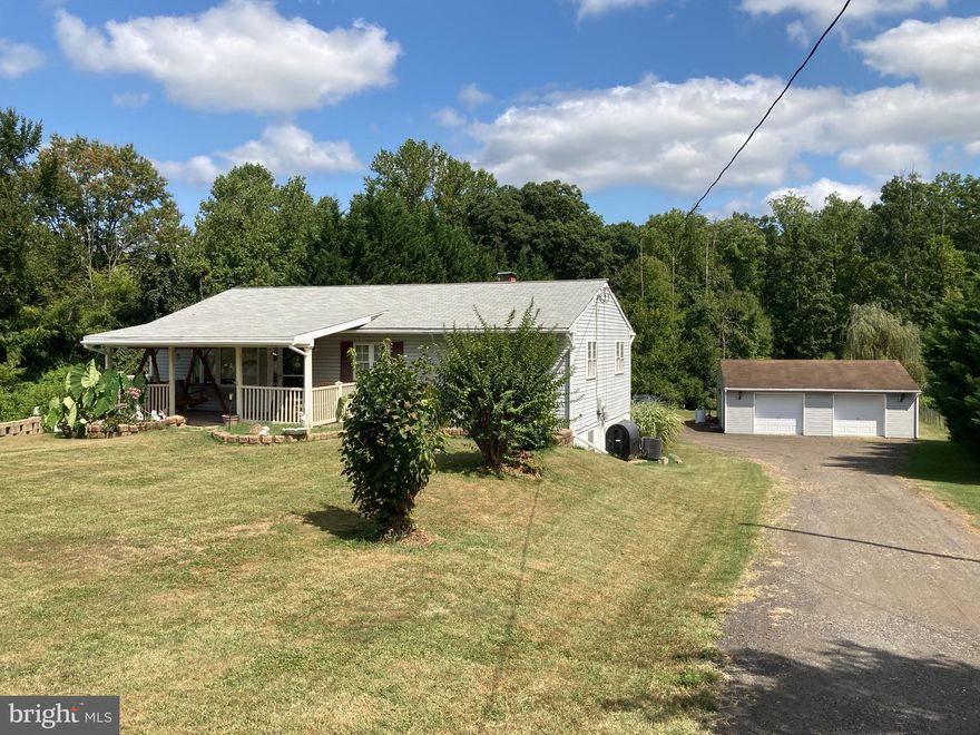 Cozy and Comfortable 3 Bedroom 2 Bath Rancher on 1.6 Acres!  Oversized 2 Car Garage with Electricity.  Wrap Around Deck with Covered Porch in Front and Rear.  Central A/C.  Hardwood Floors.  Bright and Sunny!  Ceiling Fans.  Vegetable Garden in Rear.  Circular Driveway with Plenty of Parking.  Basement with Ground Level Walkout.  Very Livable.  Needs TLC.  A Great Opportunity!  A Great Place to Live!