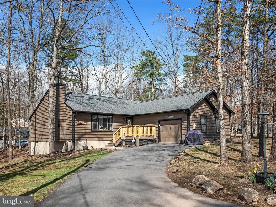 Beautifully Updated Rancher in Gated Lake Community!
This spacious one-level home offers nearly 1,800 square feet of comfortable living, featuring large rooms, vaulted ceilings with a skylight, and a cozy wood-burning fireplace in the living room. Freshly painted in a neutral palette with new flooring, it’s move-in ready! The exterior has just been stained, and the new front porch adds a delightful touch of curb appeal. The updated kitchen boasts a breakfast bar, an attached dining area, and new stainless steel appliances. The expansive primary suite includes a luxurious attached bath. Nestled on a level, wooded corner lot in a quieter section of this 240-acre lake community, this home offers both privacy and charm. Come bring your boat and enjoy the many amenities that Lake Holiday offers: 3 sandy beaches, clubhouse with fitness room and picnic areas, fishing pier, marina, tennis/volleyball/pickleball/basketball courts, walking and hiking trails, dog parks and a 24/7 security gate. Don’t miss the opportunity to make this beautiful home in a vibrant lake community your own!