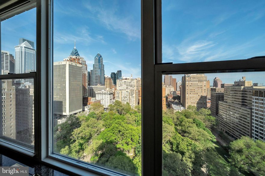 A HOME IN THE SKY with a Rittenhouse Address and Rittenhouse Square Views!
Elevate your lifestyle with this extraordinary residence on the 21st floor in a boutique building, featuring two private terraces offering breathtaking views of Rittenhouse Square to the east for stunning sunrises and to the west for serene sunsets. This custom-designed home, spanning an impressive 3,772 square feet, was crafted by a prominent developer for personal use and thoughtfully enhanced by the current owner. With unmatched elegance, timeless design, and iconic views, this residence defines luxury living in Philadelphia. This home features signed wallpaper art by pop artist Roy Lichtenstein.
The home showcases spectacular millwork with arches, alcoves, coffered ceilings, and  inlaid hardwood floors lending timeless sophistication to every room. A gourmet kitchen, perfect for entertaining, flows seamlessly into a dining and living area bathed in natural light from wall-to-wall windows. Two fireplaces create warmth and ambiance, while a fully integrated sound system enhances your everyday living experience. Convenience continues with a  separate laundry room and direct access to the trash chute. 
The expansive primary ensuite is a retreat in itself, featuring a private balcony, south- and west-facing windows, a soaking tub/jacuzzi, a separate shower, a sauna, water closet and bidet, and two walk-in dressing closets. Beyond the primary suite, the home offers two additional bedrooms, a den with a built-in bar, and a versatile office space.
Upon entering, you are greeted by a welcoming foyer and a bronze girl fountain, setting the stage for the elegance that lies ahead. From the foyer, a hallway leads to the private bedroom quarters, while the open dining room, balcony, living room, and kitchen provide a magnificent space for entertaining, enhanced by unparalleled views of the Square and city skyline.
This is not just a home; it’s a masterpiece in the sky. Experience the ultimate in luxury living on Rittenhouse Square.