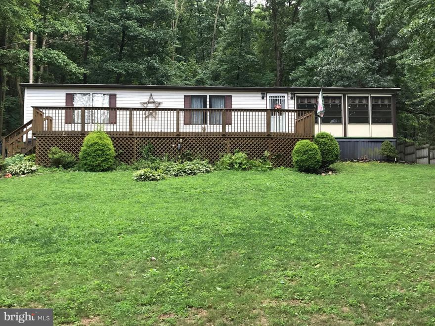 A great start for any family or someone looking to downsize. This 2 bedroom, 2 full bath rancher boasts a large deck out front overlooking a peaceful view. The open floor plan living room is attached by sliding glass door to the sunroom. 3 sheds with the property and almost everything inside of the property goes with a full priced offer. (Stickers on select items because of the recent estate sale.)