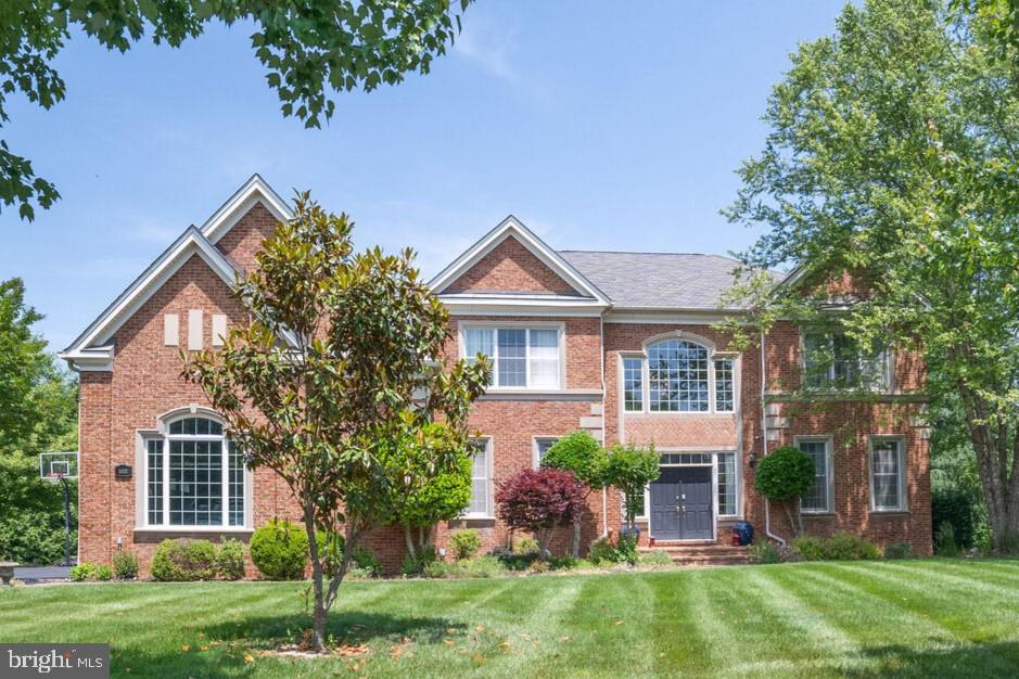 Gorgeous Toll Brothers estate in coveted Patuxent Chase. Beautiful lot showcases a handsome brick entry, leading into a beautiful grand two story foyer featuring dual curved staircases opening to opposing formal living and dining rooms complemented with intricate molding, trim, and light filled windows Marvelous two story great room boasts a soaring coffered ceiling, floor to ceiling windows, and a dramatic stone fireplace. The chef's kitchen offers modern elegance and the comfort of sleek granite counters, gas cooking, a huge center island with seating, display cabinetry, a corner pantry, pendant lighting, and a breakfast dining area. A welcoming 1st floor bedroom with full bathroom is an ideal attractive bonus for guests or working from home. Ascend to the upper level by the back stairway or the beautiful dual curved staircases, to the magnificent primary bedroom suite, featuring a tray ceiling, decorative columns, a separate sitting area, and a walk in closet. The beautiful primary bath offers separate vanities, jetted tub, oversized shower with seating, and an additional huge walk in closet. Three graciously sized en suite bedrooms complete the upper level sleeping quarters. The lower level features an expansive recreation room, custom bar, bonus office room, full bathroom, and plenty ofl storage space, along with walkup outside access. Enjoy the lovely rear deck, leading to an charming brick patio and gazebo, overlooking mature trees and endless views. Don't miss this one!