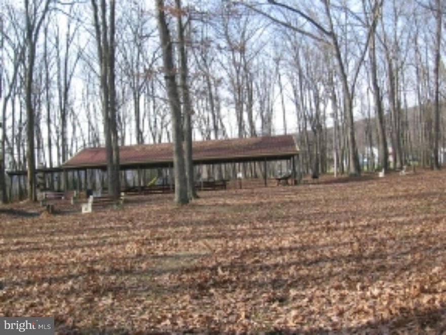 2.5 Acres surrounded by 2 State Parks in Ryan & Rush Township.Level Lot.  Woods/Clear. Includes a large Pavillion  & fireplace for your outdoor adventures. Brick building with restrooms. Secluded setting. Great use for Hunting,Recreational ventures or a perfect area to build your dream home!