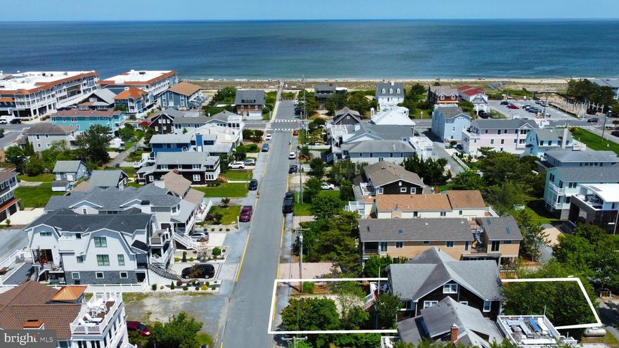 Positioned on the first beach block in downtown Bethany Beach, this quintessential coastal cottage perfectly blends classic charm with modern amenities. Just steps from the ocean and a short stroll to boutique shops and delightful restaurants, this home is offers the ultimate coastal lifestyle. Enjoy outdoor living on the spacious deck or relax in the inviting screened porch. Inside, the combined living and dining area boasts nostalgic wood plank floors, a charming exposed beam ceiling, and  beautifully crafted built-in cabinetry, creating a warm and welcoming place to gather after a day on the beach. With two comfortable bedrooms and a full bath on the main floor, plus three additional bedrooms, a powder room, and a cozy reading nook upstairs, there's plenty of space for family and guests. The ground floor expands your living area with another full bath, laundry room, game room and ample storage. Outside, the fenced backyard features an outdoor shower and plenty of space for grilling and yard games.  Offered fully furnished, this home makes a nice investment property with a proven rental history. Enjoy this coastal retreat as-is or build your custom dream home on this 40 x 125 lot on one of the most coveted streets in Bethany Beach;  either way, this is the perfect location to create lasting memories with those that mean the most to you!