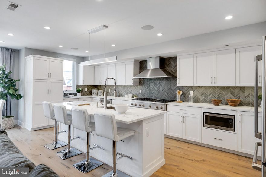 Most affordable newer construction residence in Queen Village! This fully custom home has extremely low taxes at only $2,450 in 2022. That's over $100,000 in tax savings compared to similar homes in the area over the next 8 years.  This new construction, 3,280 square foot home boasts high end features, including an in-unit elevator, wide plank hard wood flooring, custom closets, glass shower enclosures, handcrafted Amish cabinets, quartz countertops, tile back splash, GE Cafe' kitchen appliances, Kohler fixtures, and Pella ProLine Windows and a private garage with direct access to unit. The building shares a common courtyard which provides access to each of the individual units. The home has 3 bedrooms, 2.5 bathrooms, an office/den space off the main living area and a large finished basement. Don't like stairs?  No problem, this home has a private elevator providing access from the basement to the main living level.  As you head to the main living area, you'll start to see the custom touches. The living room, dining area and kitchen are the remaining spaces on the main living level. The living room has a linear fireplace that is beautifully accented by a quartz shelf under the television. The dining area runs along the floor to ceiling windows and can easily accommodate a table for 8. Opposite the living  room is your true chefs kitchen. Custom handcrafted Amish cabinets with pull out drawers, quartz countertops, bar with seating for four, a main sink and prep sink. GE Cafe' appliances including a 6 burner cook top with built in griddle, and double oven. The kitchen also has a beverage fridge to keep your favorite drinks cool. The built in Sonos sound system makes it easy to play music or watch your favorite movie. Heading upstairs, you'll enter the bedroom floor. 3 bedrooms, 2 full bathrooms and a laundry room encompass this level. The rear bedroom has double exposures and can easily accommodate a queen bed, the middle bedroom has a southern exposure, and a walk-in closet. Between the two rooms is the hall bathroom with large tub, sliding glass doors and double vanity. Across from the bathroom is the laundry room with full size washer and dryer, large quartz counter, plenty of cabinet and storage space and a farm sink with hanging bar. The primary bedroom is a spa like retreat. MASSIVE walk-in closet,  huge room with plenty of space for a king bed, night stands, dresser and vanity and a wall of windows with views of Center City and the Benjamin Franklin Bridge. The primary bathroom has a water closet, double vanity and an 8+ foot shower with rain head and four body jets.  If that wasn't enough, the over 700 square foot roof deck is just upstairs.  The wrap around roof deck was built to have two sperate areas for entertaining.  The rear portion has an outdoor style kitchen with sink, cabinet and a KitchenAid grill with Searing Main Burner and Rotisserie Burner!  There is also room for a large dining room table that can hold at least 8 people.  The front portion of the roof deck faces north and has panoramic views from the Benjamin Franklin Bridge to Center City.  Sonos sound system with wired TV hook ups are also available on this side of the deck and allow for amazing outdoor entertaining or relaxing on a beautiful summer night. This home was built in 2020 and is under a FULL 10-year tax abatement, which is over $100,000 in taxes savings compared to similar homes.   The owner is a licensed real estate professional.  Please arrange a time to come tour this beautiful home before it's gone!