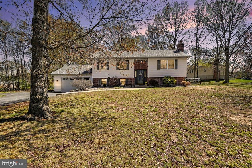 COMPLETELY turn-key! Well maintained and stylishly updated, 4-bedroom, 2 full bath bi-level situated in the family-friendly community of Arundel in the Elk Neck area, with close proximity to the Elk River, Rt 40, I-95 and the Delaware State Line. Main level highlights include a living room featuring beautiful hardwood flooring and a striking brick fireplace with a mantel as well as an updated eat-in kitchen. Details include white cabinetry, sleek granite countertops, ceramic tile flooring, stainless-steel appliances, farmhouse sink and sliders leading to a 21' X 12' deck. Ideal for entertaining and family gatherings. Additional main level features include 3 roomy bedrooms, all with hardwood flooring and a full bath. Lower-level details include a family room with LVP flooring, 15' X 23' primary bedroom with a cozy woodstove and LVP flooring, recently updated full bath with a large walk-in tiled shower, mudroom and laundry area. The oversized attached 2-car garage is accessed by doors in the mudroom and includes 2 convenient man doors and a 10' ceiling. Upgrades include an architectural shingled roof added 3/2026, lower-level bathroom remodel (2023), insulated garage door (2018), lower-level LVP flooring (2018), granite countertops (2021) and a "smart" water heater added in 2021. Exterior features include attractive landscaping, large gardening shed and rear fenced yard with a play set and firepit. Perfect for children and pets to safely run and play. If you are searching for a move-in ready, spacious, recently updated home located in a peaceful and family-friendly community, your search is over... 107 White Pine Circle... A PERFECT place to call HOME!!!