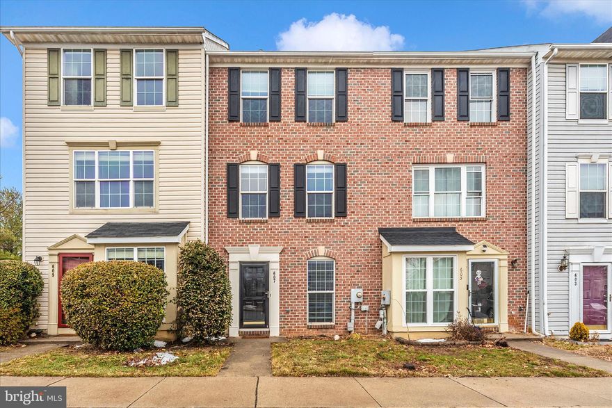 Move-in ready, brick front, 3 level home on a quiet street is light, bright and freshly painted. Enter the main level to gleaming hardwood flooring, an open floor plan with living/dining area & kitchen with white cabinets & SS appliances-brand new stove & microwave. 2nd floor offers a spacious family room with gas fireplace, full bath, laundry & front facing bedroom or office. Upper level features 2 bedrooms, one of which is the primary, shared luxury bath that includes a soaking tub, separate shower, & double vanity. Fenced rear yard is charming with a paver patio & shed. 2 assigned parking spaces right in front of the home plus plenty of visitor spaces. Brand new roof in 2023 with 50 year shingles! A/C unit replaced in 2021. New attic insulation in 2022 with R-49. Sliding glass door replaced 2023. Super convenient location close to all major commuter routes and bus stop. Low HOA fees of $49/mo plus a once a year $59 fee. The HOA handles front yard lawn maintenance & snow removal from common sidewalks.