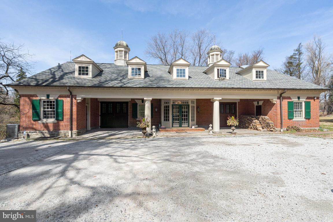 One of a kind historical home on a beautiful street in the coveted St. Martins neighborhood of Chestnut Hill. 511 West Moreland Avenue was originally built approximately 100 years ago as a carriage house for the adjacent estate and was lovingly transformed into a charming family home in 1986. Totaling 6,720 square feet with six bedrooms and three and a half bathrooms, each room of this house showcases original architectural details and modern enhancements. Drive down the private driveway where you are welcomed to this beautiful red brick home with two grand pillars, two sets of carriage doors, gas lit porch lights from New Orleans, and a grand double door entrance. There is easily parking for six cars right in front of the house. Enter into the foyer which opens to the formal dining room and living rooms. In the living room are beautiful exposed wooden beams, a gas fireplace, and a wine room. The magnificent kitchen is an entertainers dream, featuring a large center island, custom wood cabinetry, granite countertops, Sub-Zero refrigerator and freezer, a GE double wall over, trash compactor, Miele dishwasher, and Capital Culinary Series cooktop with range hood. The open kitchen has ample space for an oversized dinner table and adjacent is a family room with another wood burning fireplace. Unique to this part of the home is an original barn stall that has been converted into an office. Off the kitchen is a wraparound deck looking over the expansive back yard. The master bedroom completes the first floor. It features the original tin ceiling from the carriage house and an ensuite bathroom with a beautiful soaking tub, double vanity and a stall shower. The entire back wall of the master bedroom offers tremendous closet space. The second floor of the home has five bedrooms all offering great closet space, many of it creatively built into the walls. A great addition to the upstairs is a second family room with a full kitchen. There is a private entrance from the front of the house to this space, giving it flexibility to be used as a legal second residence. A washer and dryer and two full bathrooms can also be found on this floor. There is an unfinished basement, perfect for storage, or once finished could be great additional entertaining space. The private backyard features the original walled garden that is currently being used as a vegetable garden. Beyond that is a wide fenced in backyard with a hot tub. Chestnut Hill’s Valley Green trail is directly behind the backyard as well as Springside Chestnut Hill Academy. In addition, the Philadelphia Cricket Club and downtown Chestnut Hill are all in walking distance. This is only the third time that this house has been for sale.