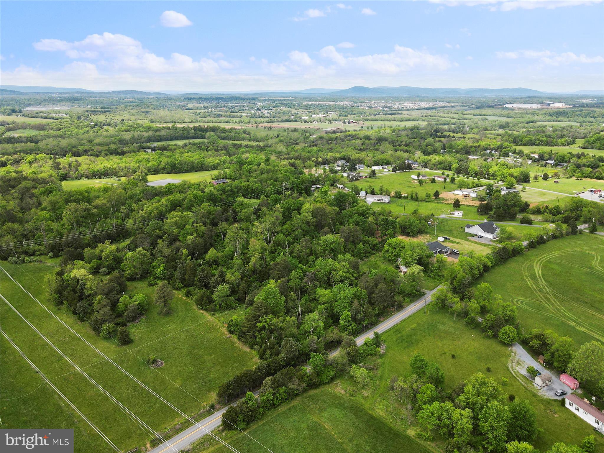 Wooded 9.91-acre lot surrounded by farmland. Quiet setting with easy access—just over 5 miles to I-81 and 10 minutes to public Potomac River access. No HOA. Great spot for a home or land investment.