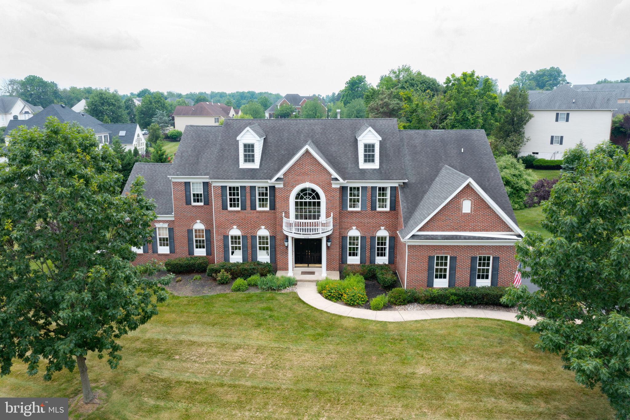 Set on a Premier, One Acre lot this elegant brick-front estate home, blends classic appointments with today's lifestyle. Enter into a soaring 2-story foyer with turned
staircase and hardwood floors. Each room is open and bright with expansive 9 ft. ceilings and 8 ft. doors on both the 1st and 2nd floors. Formal Living and Dining Areas are nicely appointed, finished with hardwood floors and neutral color palette, perfect for entertaining and family gatherings. A home office is now a MUST and this bright private study located on the main level is the perfect spot. The heart of the home is the fabulous gourmet kitchen w/ upgraded appliances, 5 burner Samsung Stove, tile back-splash, granite counter tops and large island. A Sunlit 2-story Breakfast room opens to the stylish Family room w/ wood burning fireplace, all providing gorgeous views of the patio, lush gardens and inviting pool. The grand conservatory is an amazing upgrade that can be utilized as you wish. The high ceilings and exquisite lighting make it a stunning, yet cozy gathering space. Upstairs the Owners Bedroom Suite features tray
ceiling, tremendous sitting room, walk-in closets and a lavish bath. There are 3 additional Bedrooms,
1 a Princess suite and 2 ample size bedrooms share a Jack and Jill bath. The quality
continues to the Lower Level where you will find a freshly painted finished area with a custom Bar.
Last but Not Least the backyard has been transformed into a private oasis. A large
custom heated pool, multiple seating areas and lush gardens are the prefect backdrop to
this amazing home. Luxury Living at its Best! Recent notable upgrades include new vinyl siding, updated powder room, updated mud room in 2021 and fresh paint throughout. This community features a walking path through serene wooded area and is located 4 miles from center of Doylestown. Estates of Warwick Lea is also part of Central Bucks West High School.