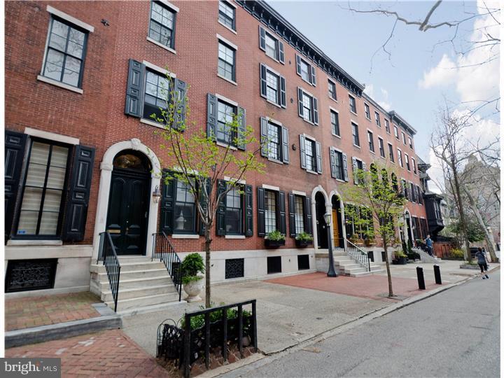 Truly a rare opportunity to own a triple-mint, turn-key home on distinguished Delancey Place. Situated in the center of block, this classic pre-war home has been meticulously renovated. With three exposures to the north, south and east, the house floods with natural sunlight and boasts unrivaled open skyline views from the top level deck. Enter through the handsome foyer to the generously proportioned living room /dining room which features faux Parquet de Versailles flooring offset by an elegant gas fireplace framed in a striking mantel. A chef's dream, the eat-in kitchen has been masterfully crafted with top-of-the-line stainless steel appliances by Sub-Zero, and Wolf. There is a comfortable seating area off the kitchen and a home management area. A beautiful wood staircase leads to a central gallery and library. This quite retreat, also with a fire place, may also be used as a guest bedroom with custom built-ins and full bath. There is a home office with built-ins. Off the 2nd floor gallery there is a generous sized living room with high ceilings, wood flooring, moldings, fireplace and wet bar. The third level master suite faces south over Delancey Place and offers a faux fireplace, walk-in closet and marble bathroom. Completing this level is a bedroom, full bathroom and laundry. The fourth level has additional guest quarters with bath, sitting room and a landscaped deck. For added convenience, this home features on site GARAGE parking, lower level gym, an elevator to access four levels, central heating, air throughout and 2 full size laundry rooms.