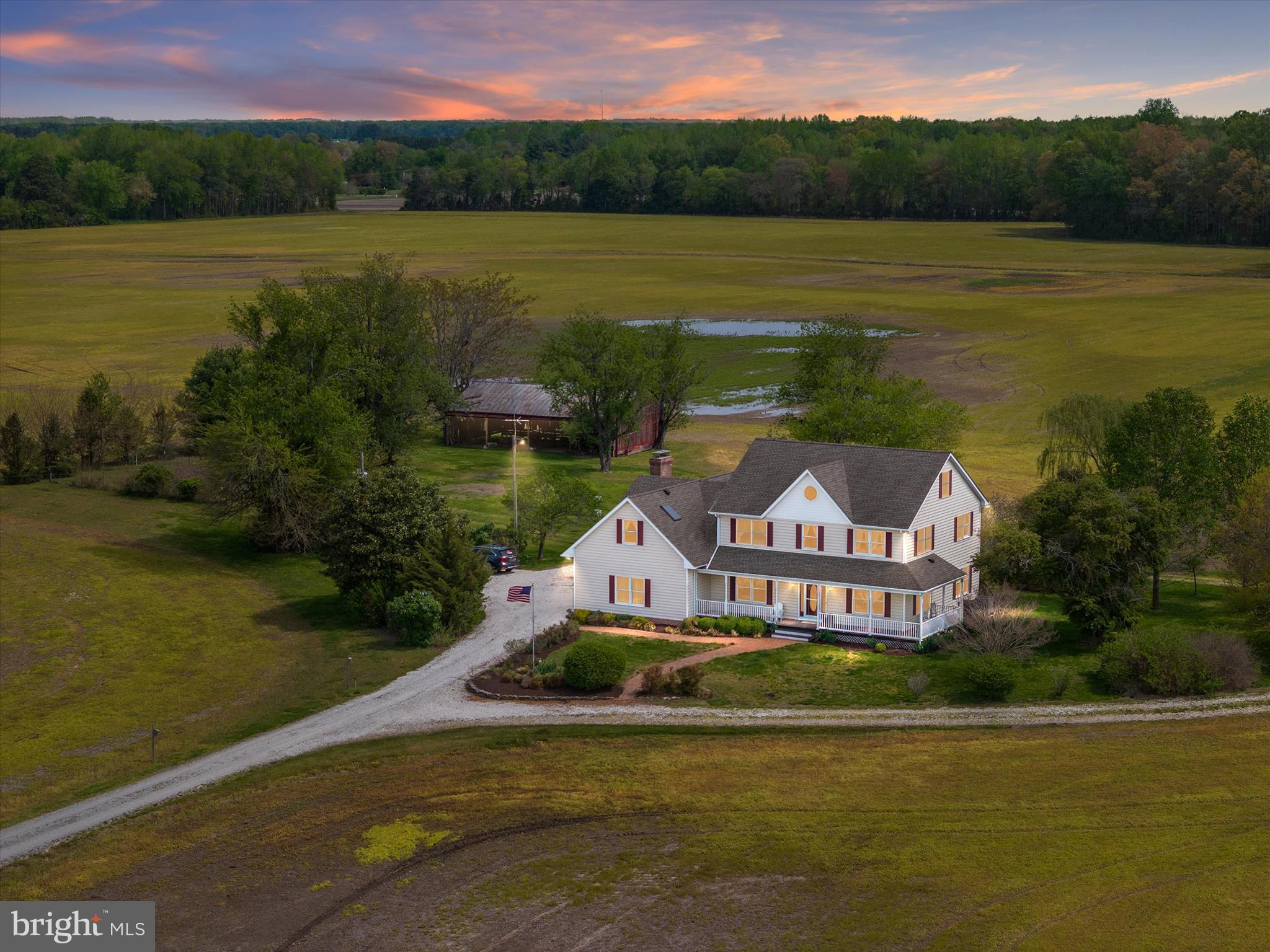 Agents - see MLS remarks for address.
Welcome to Thanksgiving Farm, an exceptional opportunity to own nearly 100 acres of prime Eastern Shore farmland just minutes from charming small towns and within easy reach of Ocean City, Annapolis, and major airports. This versatile estate includes two parcels – one is a separate, buildable 13.81-acre lot, offering future flexibility or potential multi-generational living. Tucked at the end of a long private drive, the main home is a thoughtfully designed farmhouse that perfectly blends classic charm and practical living. The home features four spacious bedrooms upstairs, including a private primary suite with a sitting area, large bathroom, and direct access to a massive bonus room – perfect for a home office, yoga studio, sewing room, or playroom. The bonus room also has its own private staircase, making it a truly flexible space. On the main level, enjoy hardwood floors throughout, a light-filled kitchen that opens to a casual dining area and cozy family room with a wood stove. Just off the family room, a large screened-in porch overlooks the property’s picturesque fields, gardens, mature trees, and classic barn. A formal living room and dining room round out the main level, ideal for gatherings and entertaining. There’s also a convenient first-floor bedroom. The unfinished attic—with walk-up stairs, windows, and skylights—offers the potential for a bunk room, office, or gym, while the walk-out basement is ideal for a workshop or storage and connects directly to the attached garage. Outdoors, the land itself is the true star. Of the 99.81± total acres, approximately 70 are tillable—ideal for row crops or converting to a regenerative farm. Several low-lying areas create opportunities for duck ponds or managed impoundments. The remainder of the property is wooded and absolutely teeming with wildlife—whitetail deer, turkey, and more—making it a hunter’s paradise. A large equipment shed offers ample space for tractors, ATVs, RVs, boats, and anything else you can imagine. Whether you’re looking to work the land, create a multigenerational retreat, or simply unwind in the heart of Maryland’s farm country, Thanksgiving Farm offers endless possibilities.