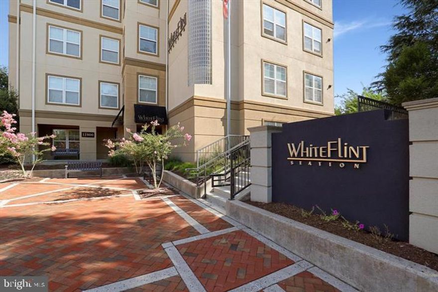 Come and view this gorgeous light filled large top level condo (over 1500 sq feet) at White Flint Station!  It is completely move-in ready and ownership pride truly shows.  This bright and freshly painted home with large windows boasts of gleaming light hardwood floors, three spacious bedrooms, built in closet shelving in master closet, two large bathrooms,  beautiful shiny kitchen cabinets with granite countertops, stainless steel appliances, open dining and living space with crown molding, and an oversized private balcony.  The unit also has an in-unit laundry room, gorgeous fireplace and two assigned parking spaces.  There is a private community patio that is perfect for entertaining and enjoying outdoor space.  Enjoy many building amenities such as a fitness center, recreation center, library, outdoor paths and a swimming pool.   Unit is on the same level as the amenities!  Location of the unit is best.  Super easy access to the unit through door 11800D which is right across from Harris Teeter!  Or, park in the garage which is on the same level as the unit.  Exceptional location off Route 355/Rockville Pike within walking distance to White Flint metro, an array of restaurants, shopping, and Pike and Rose.   And just 4 miles to Walter Reed and NIH.  Don't miss out on this beautiful condo in the most amazing location!