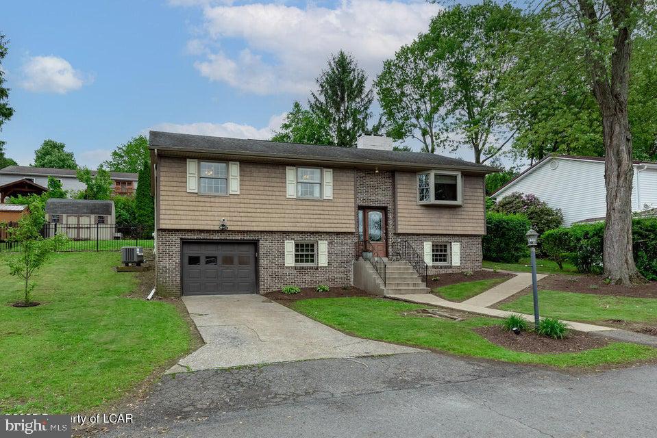 Very nice offering! Move right into this bright & airy open-concept 3 Bed, 2.5 bath Woodland Acres home with carefree laminate & tile floors throughout, neutral colors, heat pump with AC 2019, propane heat lower-level, double-sided gas fireplace, kitchen with island & quartz countertops, finished lower-level family room with half bath, brand-new hot water heater, fenced yard, shed, garage too!