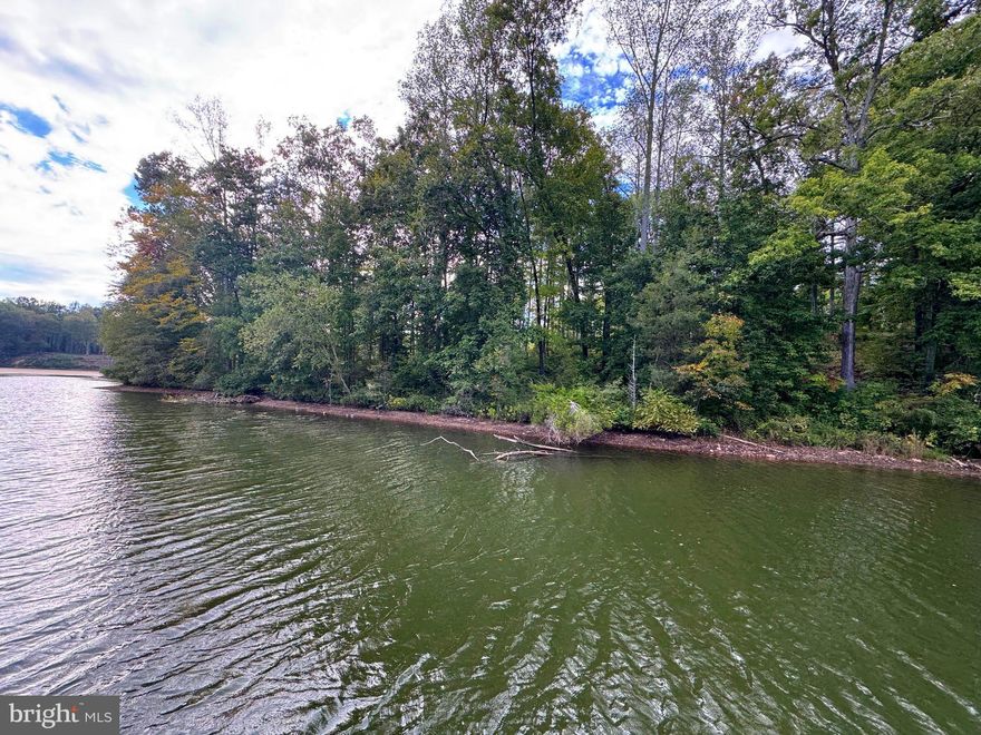 Nestled on a serene .95-acre waterfront lot with mature trees, this property offers the ideal canvas for your dream lakefront retreat. With over 100 feet of shoreline, you’ll have the perfect setting to design your custom boathouse and savor tranquil mornings by the water. Located in Compass Cove at Lake Anna, this upscale neighborhood embraces a lifestyle of relaxation and refined leisure. Residents enjoy private access to a boat ramp and a charming picnic pavilion, making it effortless to spend your days boating, fishing, waterskiing, or simply unwinding by the lake. Whether you envision quiet weekends surrounded by nature or lively days filled with water adventures, this property delivers. Soil work for a 4-bedroom conventional septic system is on file (see MLS documents). The possibilities here are as endless as the Lake Anna horizon.