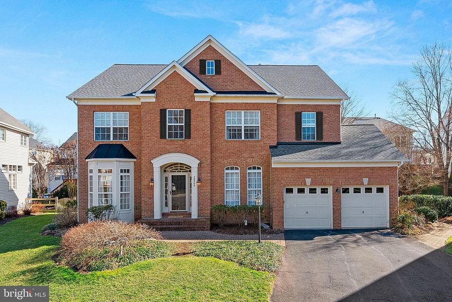 This home is truly a TEN—an impressive, beautifully updated brick-front Colonial ideally situated at the end of a quiet cul-de-sac in coveted Lowes Island. Built by The Cambridge Company, the sought-after “Beacon Hill” model welcomes you home with a charming paver walk and covered portico. The grand two-story foyer showcases a dazzling crystal light fixture, newly refinished hardwood floors that extend throughout the main and upper levels, and  stunning brand-new angled open-tread staircase featuring updated spindles, railings, and newel posts. Offering 4 bedrooms and 4.5 baths across three finished levels, this home provides exceptional space and flexibility—including 3 full baths upstairs and a lower-level den with an additional full bath. The all-new gourmet kitchen is a SHOWSTOPPER, designed to impress with an oversized waterfall Quartz island and perimeter countertops, double-height shaker-style cabinetry, a new pantry, stainless steel appliances, and new hardwood flooring. The adjacent breakfast room, lined with windows, opens to a wraparound Trex Transcend IPE deck and paver conversation patio—perfect for indoor-outdoor entertaining.

The expansive family room at the heart of the home features a fireplace and seamless flow to the kitchen having removed the wall, creating an open and inviting gathering space. Formal living and dining rooms with elegant moldings and bay windows, a bright main-level office, and an updated powder room complete the thoughtfully designed main level. Upstairs, the luxurious primary suite boasts refinished hardwood floors, an octagonal tray ceiling, and an incredible custom closet created by merging two smaller closets into one beautifully designed space. The spa-like en-suite bath includes a soaking tub, oversized frameless glass shower with new dual rainfall showerheads and surround, a double sink vanity, and a private water closet. The upper level also features a spacious secondary bedroom with en-suite ceramic tile bath and deep walk-in closet, plus two additional generous bedrooms that share an updated hall bath with new Quartz vanity top, and new plumbing and lighting fixtures. An upper-level laundry room adds everyday convenience.

The finished lower level with private exit offers exceptional versatility with a large recreation room, kitchenette (dishwasher, second refrigerator, wine fridge, granite countertops, and maple cabinetry), den, full bath, expansive bonus room for crafts or gaming with built-ins and abundant 30 bulb recessed lighting, a storage room, and a second laundry hookup. Extensive system updates provide peace of mind, including a newer roof, HVAC, and water heater, a $30,000 whole-house electronic air filtration system, irrigation system, updated lighting and plumbing fixtures, and fresh neutral designer paint. Enjoy a prime commuter location near abundant shopping and dining, Lowes Island Elementary, and access to Cascades’ exceptional amenities—five pools, tennis courts, nature trails, tot lots, and more. Tappahannock Pl is truly exceptional home in an unbeatable setting.