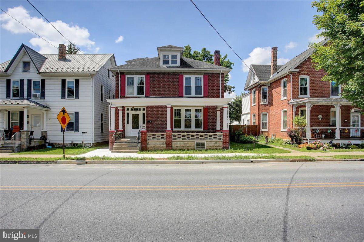 *OFFER DEADLINE: Please submit your highest and best offer no later than 1:00pm on Friday, August 1st. * Charming and full of potential, this 1900 brick Colonial is nestled in the heart of Chambersburg—just steps from the hospital, shops, and restaurants. Bursting with original character and timeless appeal, this home is ready to be loved again. Recent updates and added finished square footage provide modern comforts while preserving its historic charm. Perfect for large families, the home offers spacious living with endless possibilities. Relax on the inviting covered front porch or unwind in the shaded, private backyard—ideal for entertaining or peaceful evenings. A detached two-car garage adds extra convenience and storage. Don’t miss your chance to own a piece of Chambersburg history!