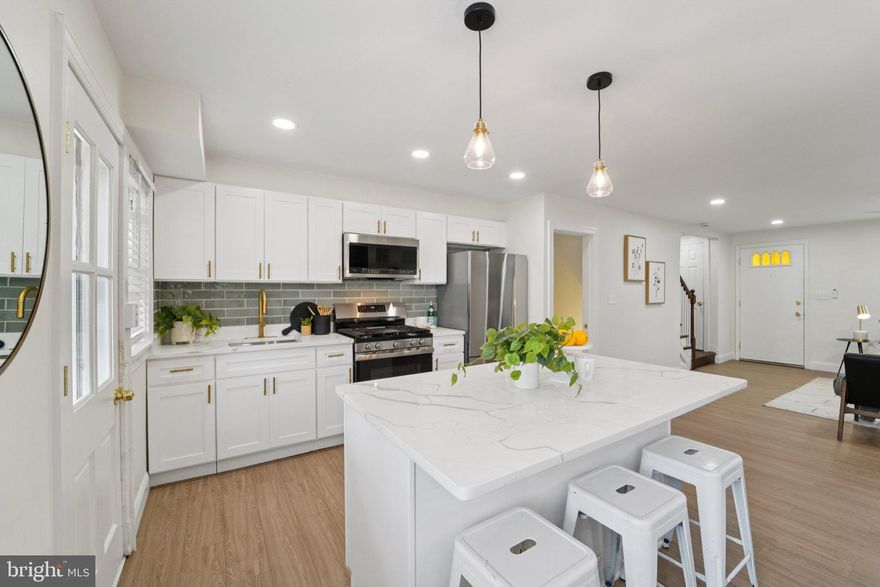 **Staging has been removed* Welcome to this Beautifully Updated 3-Bedroom, 2-Bathroom home in Baltimore City’s Edmondson neighborhood! Thoughtfully Redesigned from top to bottom, this property features Modern Updates and Stylish Finishes throughout. Step inside to find Luxury Vinyl Plank Flooring, a striking Accent Wall, and an open concept Layout. The kitchen is a true highlight with White Shaker Cabinets, Gold Hardware, Brand-New Stainless Steel Appliances, and Modern Finishes—perfect for Everyday Living or Entertaining. Both bathrooms have been updated with Contemporary Design. Finished basement with walkout gives additional space to entertain or just relax. Stay comfortable year-round with Forced Air Heating and Cooling in Every Room. Outside, relax or host gatherings on your Brand-New Deck. On street parking or private parking in the backyard. This Move-In-Ready Home offers the perfect blend of Style, Comfort, and Convenience in the heart of Baltimore City.